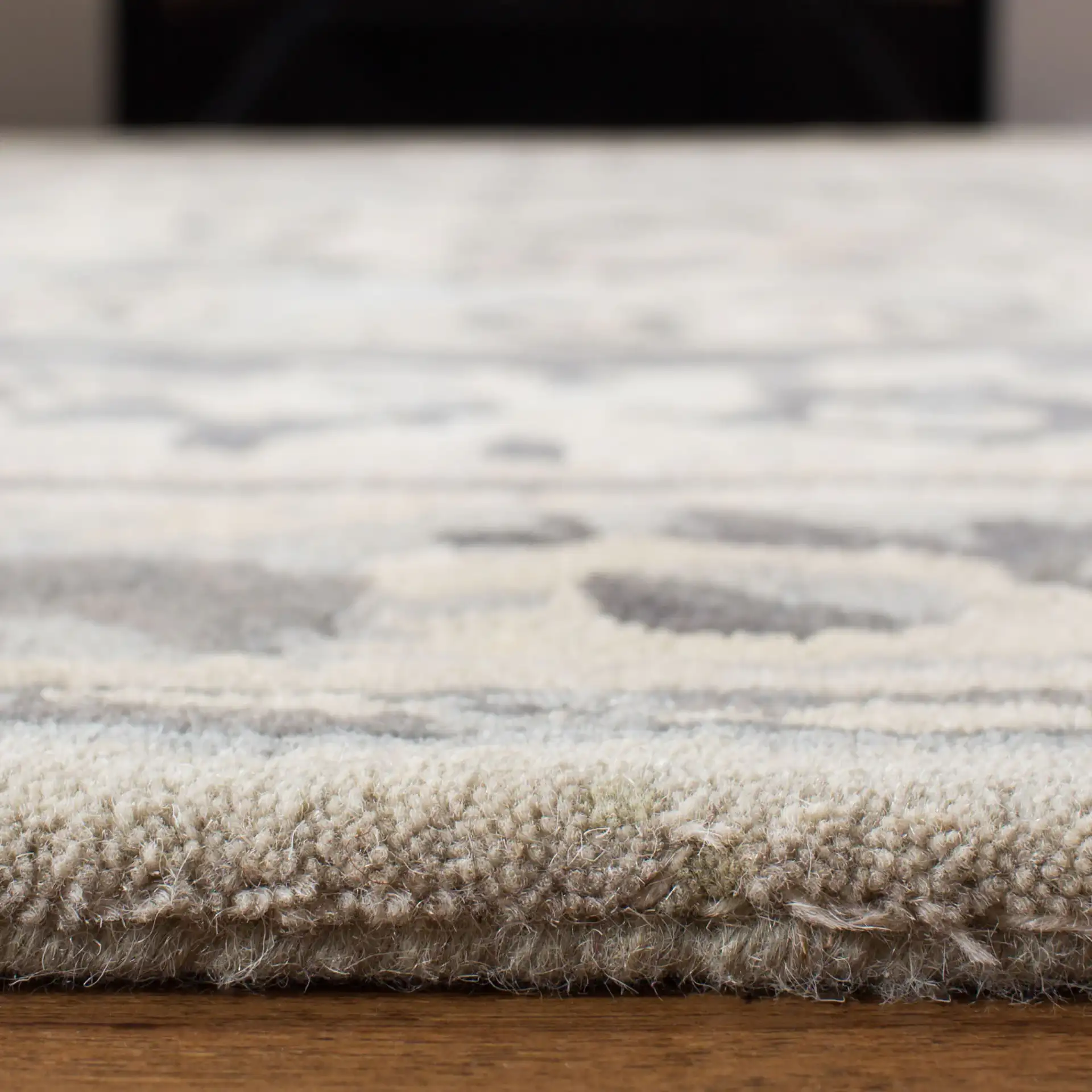 Empire Floral Medallion Hand-Tufted Wool Rug in Beige / Light Gray in a styled room