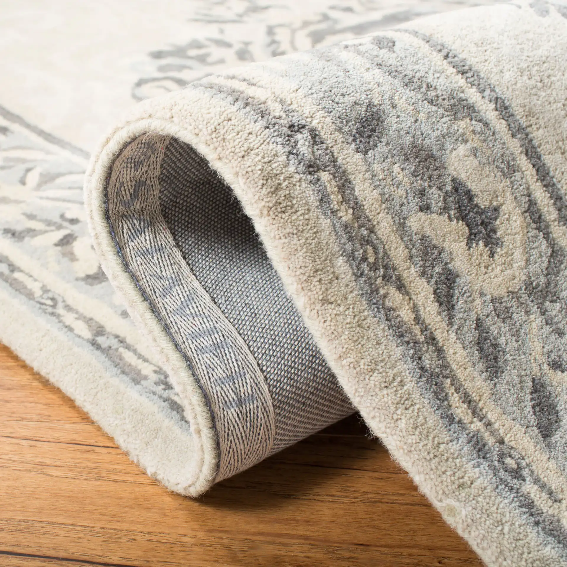 Empire Floral Medallion Hand-Tufted Wool Rug in Beige / Light Gray in a styled room