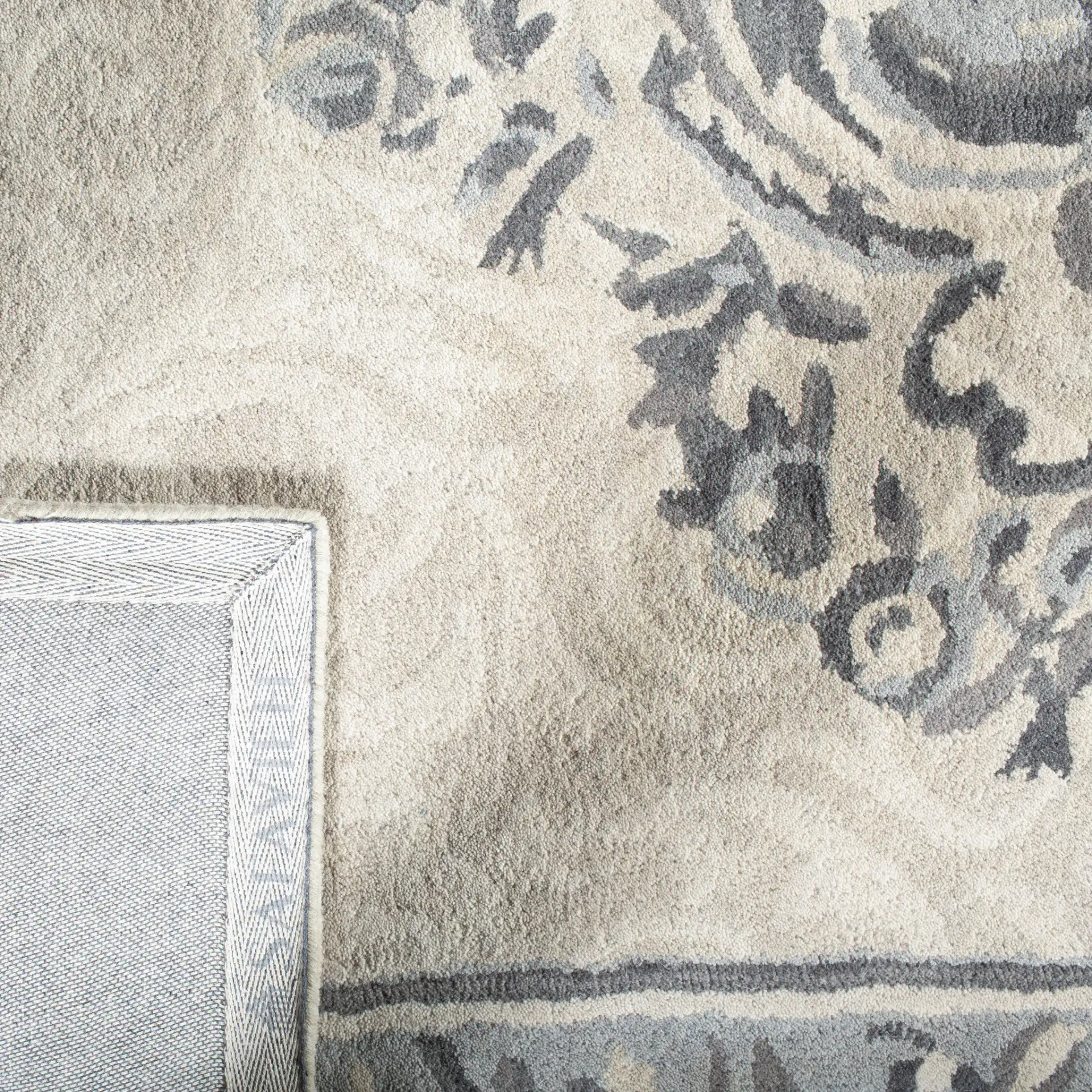 Empire Floral Medallion Hand-Tufted Wool Rug in Beige / Light Gray in a styled room