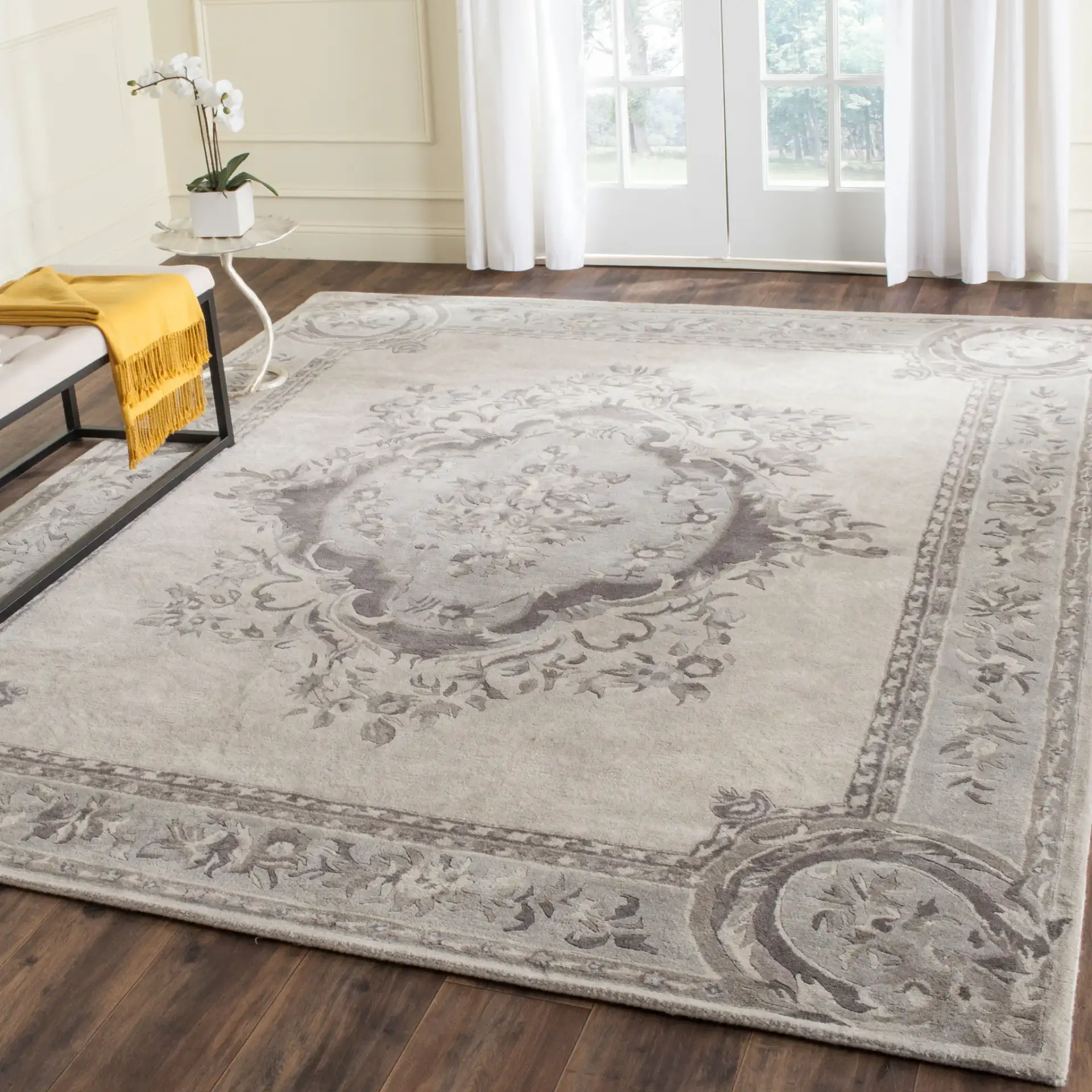 Empire Floral Medallion Hand-Tufted Wool Rug in Beige / Light Gray in a styled room