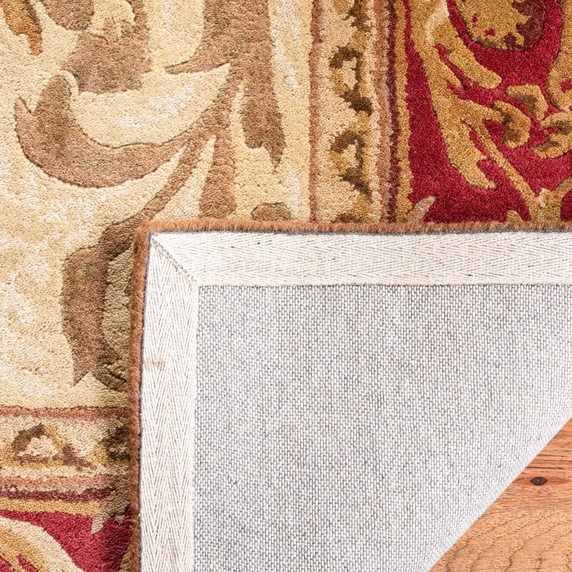 Empire Oval Medallion Bordered Hand-Tufted Wool Rug in Light Gold / Red in a styled room