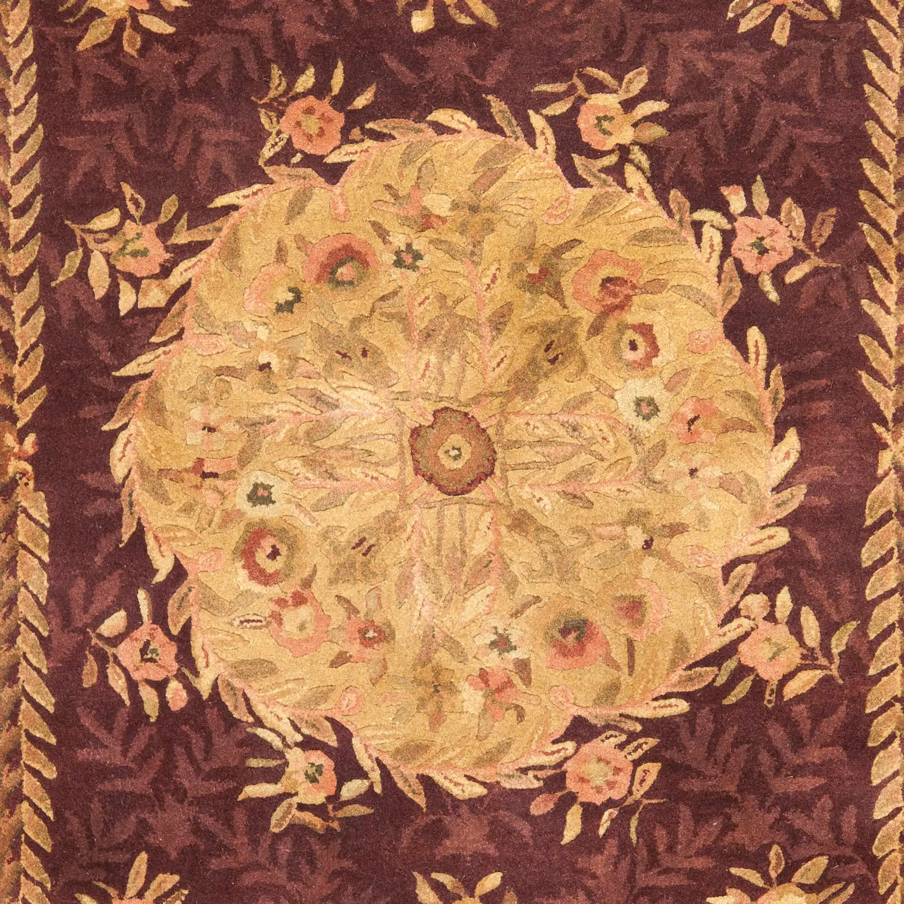 Empire Floral Rosette Bordered Hand-Tufted Wool Rug in Burgundy in a styled room