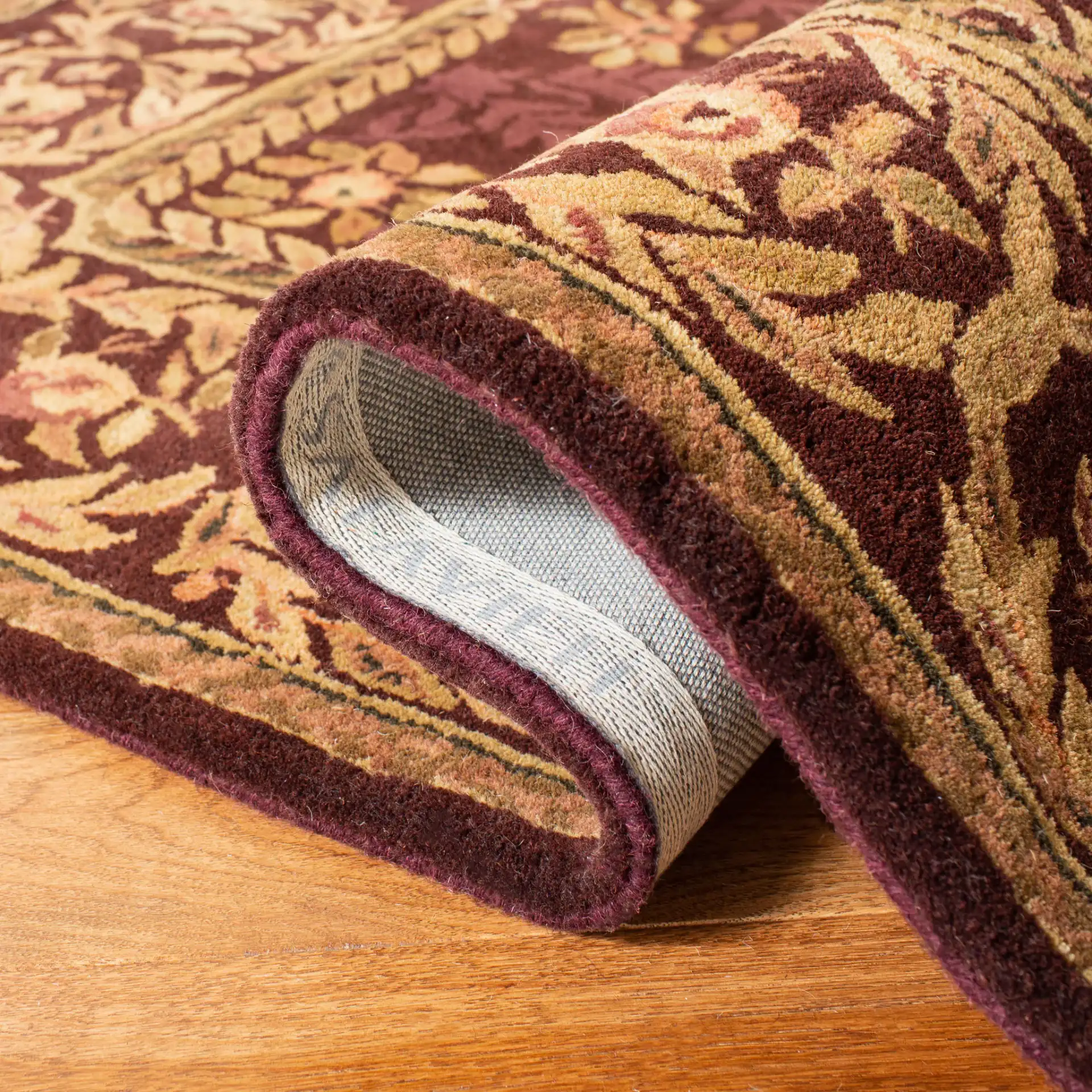 Empire Floral Rosette Bordered Hand-Tufted Wool Rug in Burgundy in a styled room