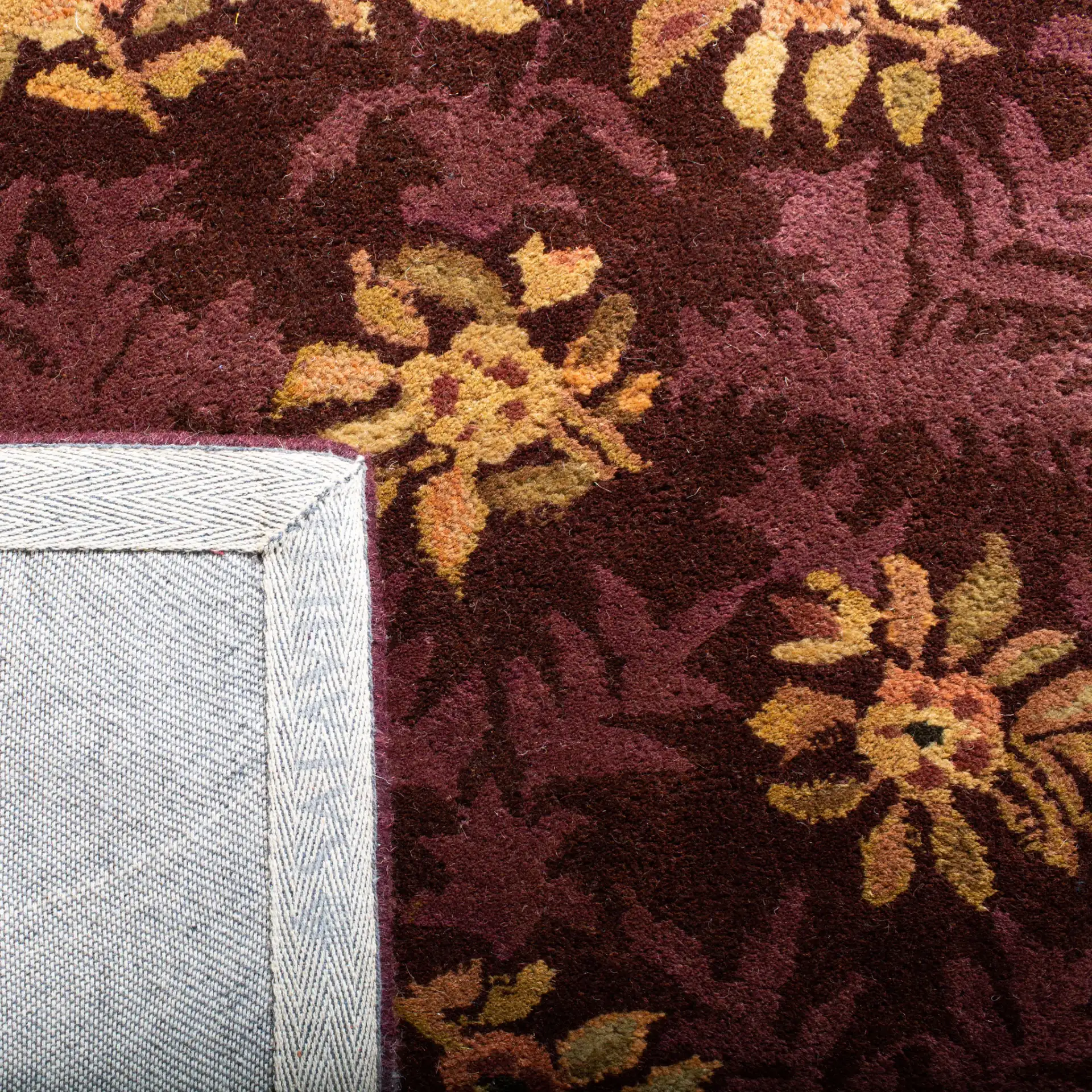 Empire Floral Rosette Bordered Hand-Tufted Wool Rug in Burgundy in a styled room