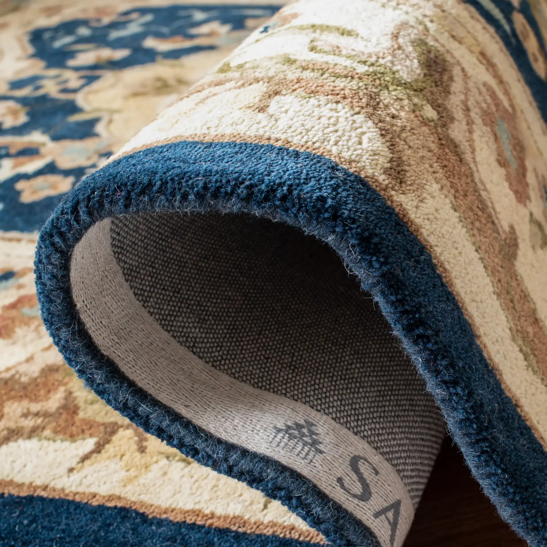 Empire Medallion Floral Hand-Tufted Wool Rug in Navy / Beige in a styled room