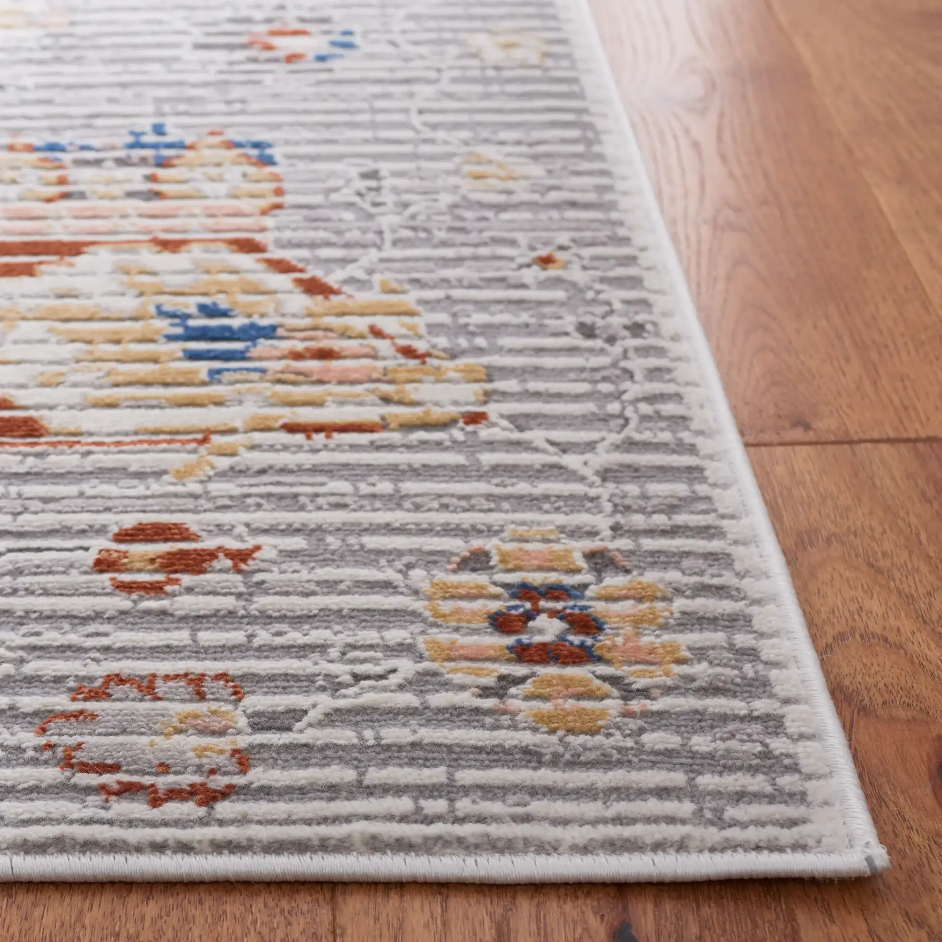 Eternal Distressed Floral Rug in Gray / Blue Rust in a styled room