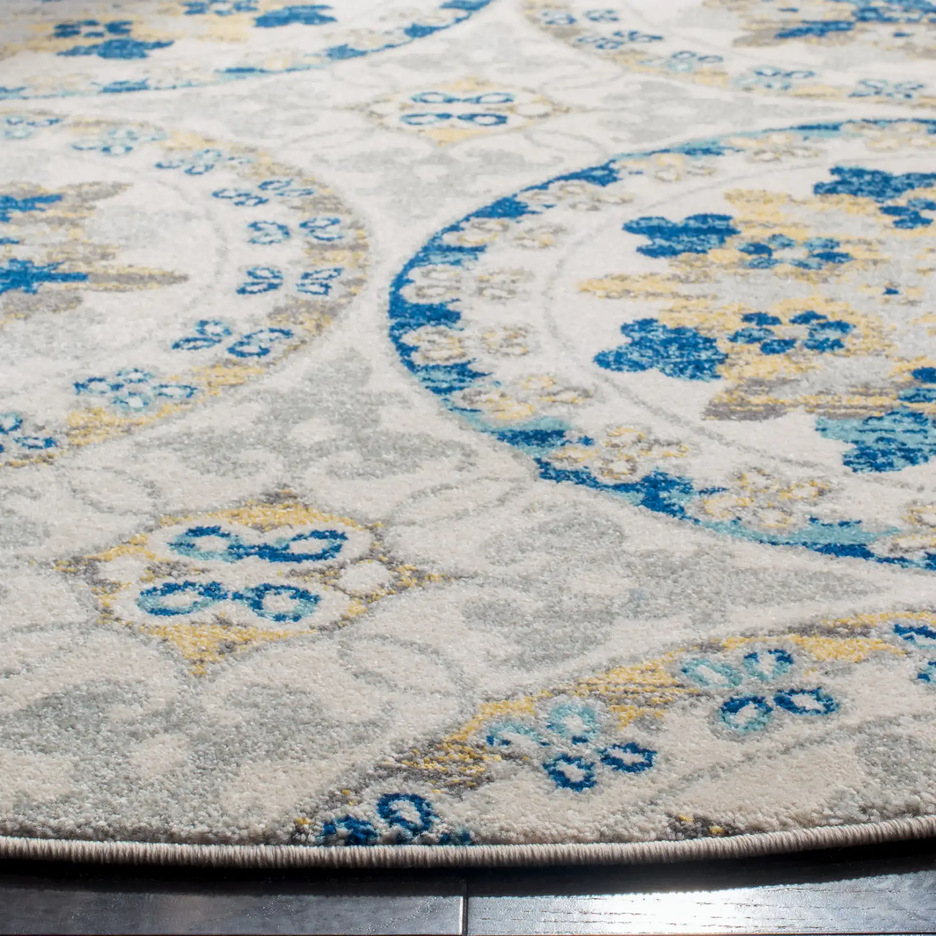 Evoke Circular Medallion Rug in Ivory / Blue in a styled room
