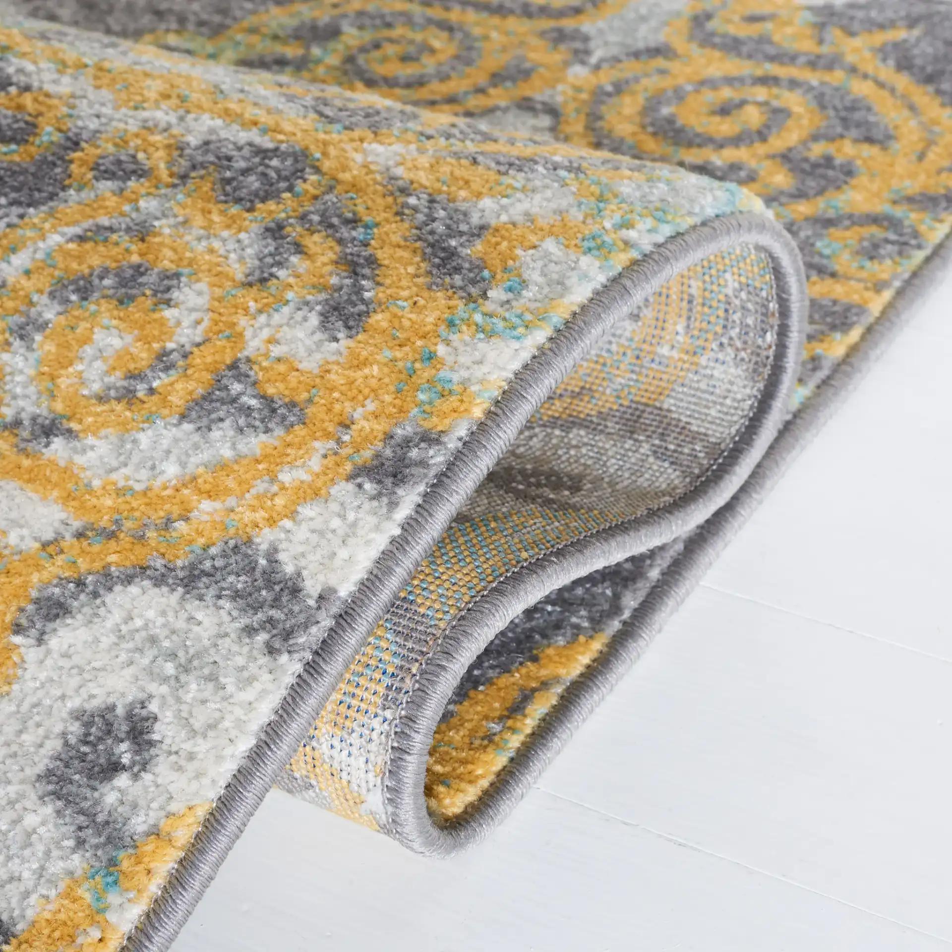 Evoke Scrolling Medallion Rug in Gray / Ivory in a styled room