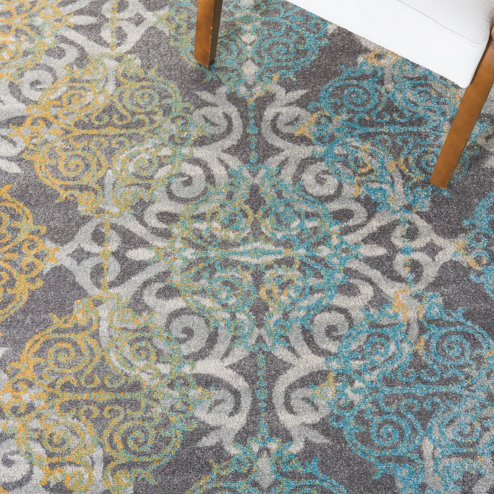 Evoke Scrolling Medallion Rug in Gray / Ivory in a styled room