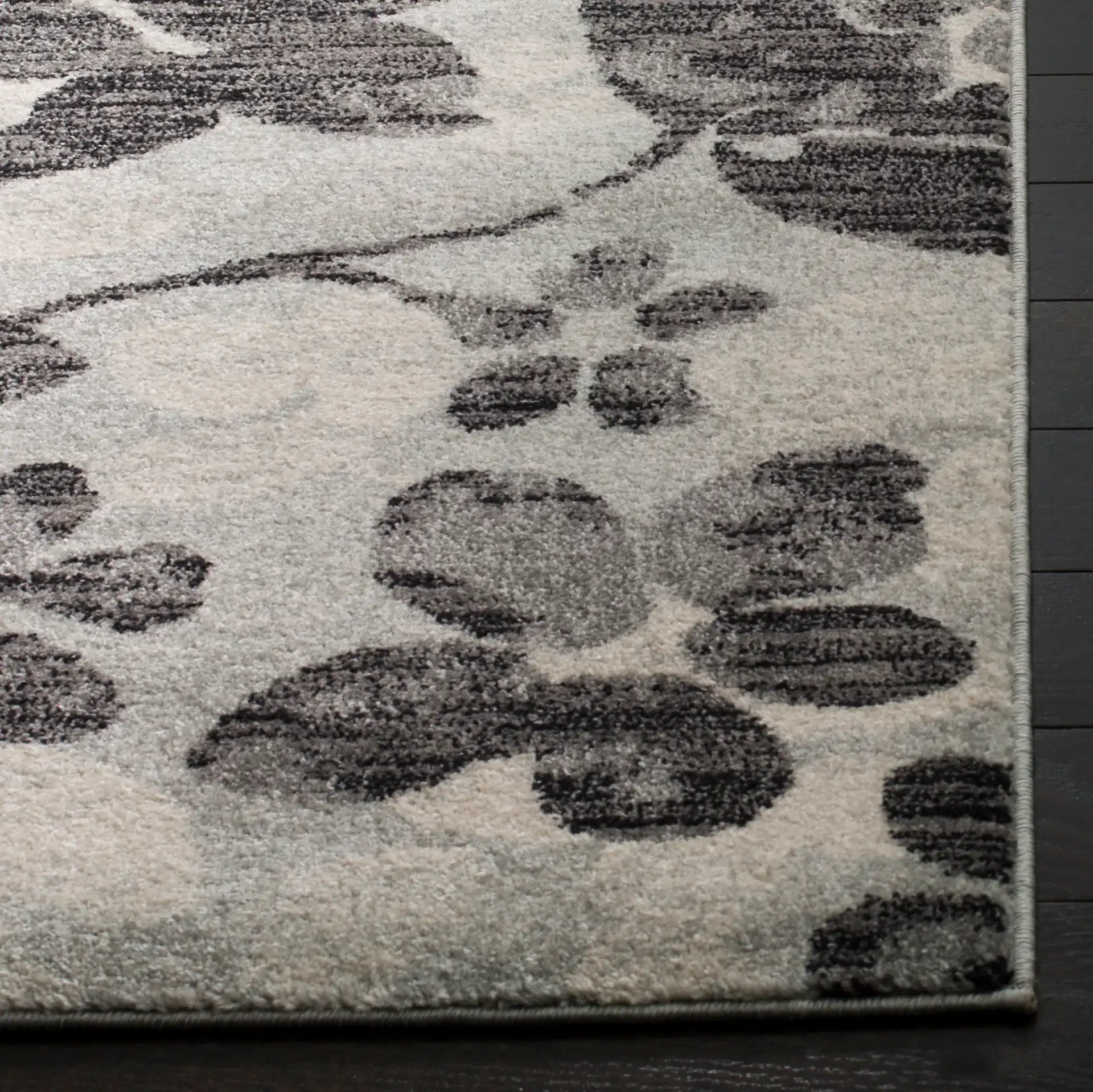 Evoke Allover Floral Rug in Gray / Black in a styled room