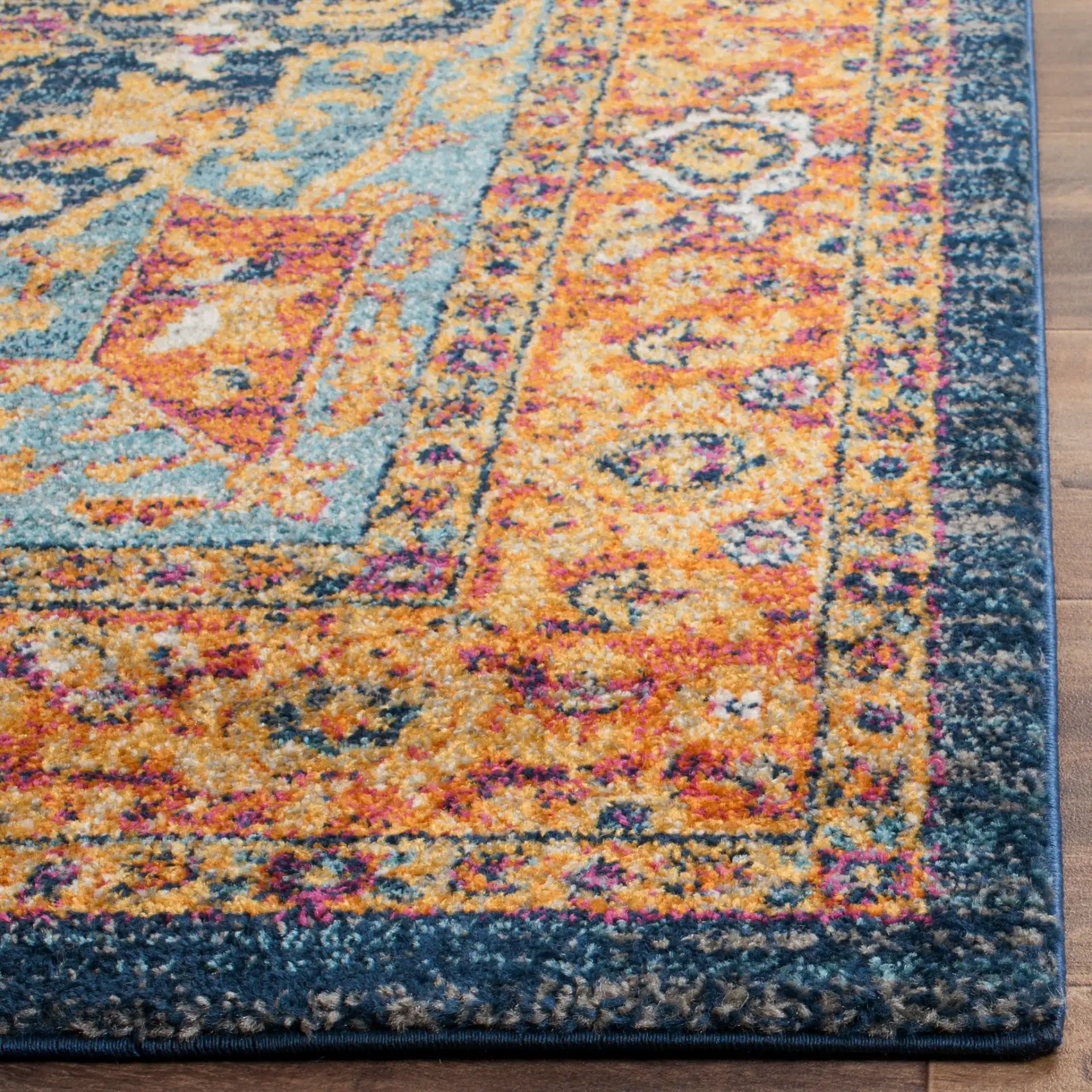 Evoke Medallion Border Rug in Blue / Orange in a styled room