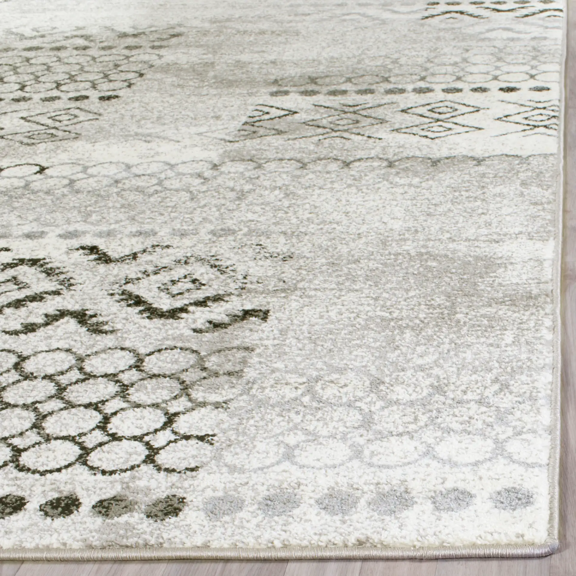 Evoke Distressed Patchwork Rug in Cream / Dark Gray in a styled room