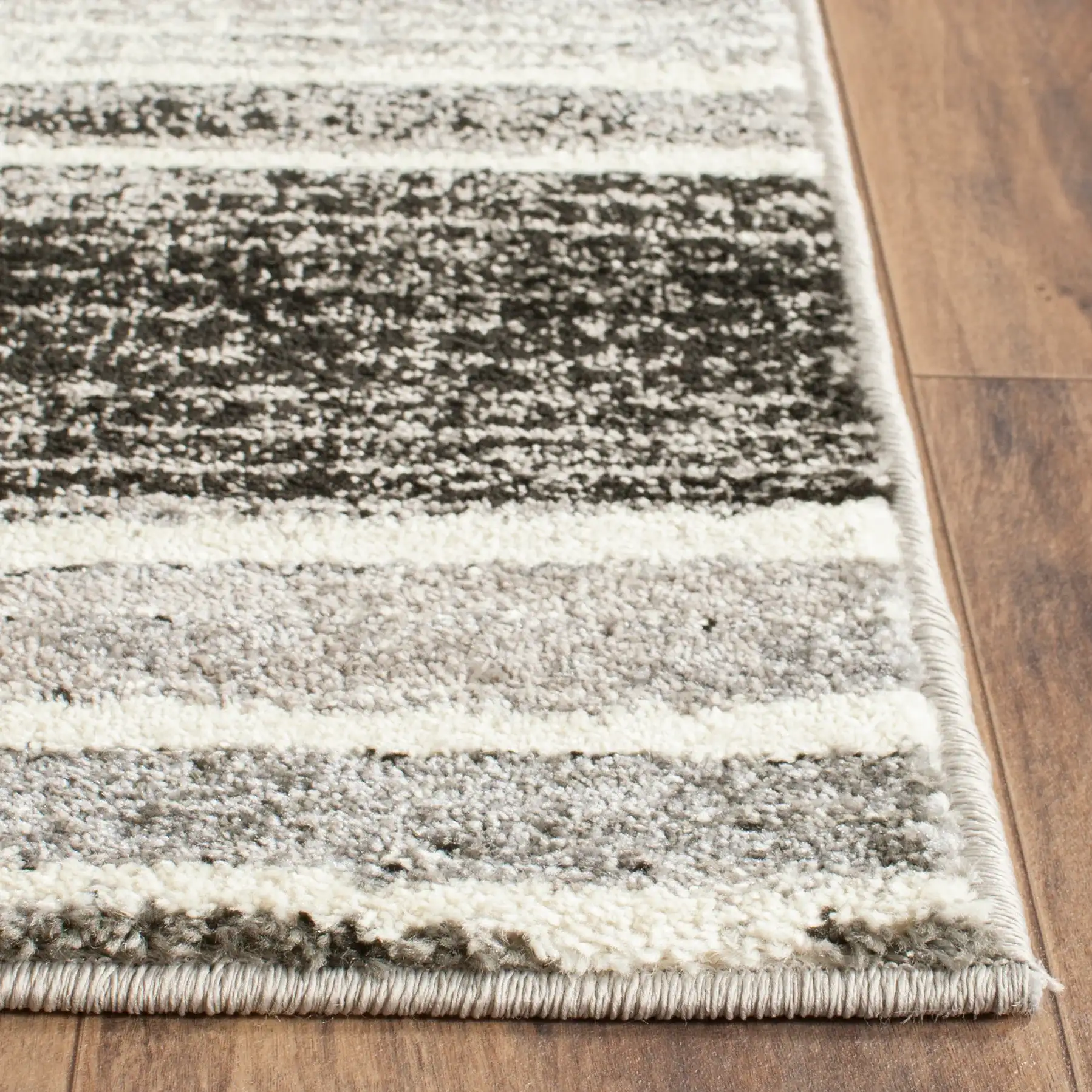 Evoke Modena Abstract Border Rug in Cream / Dark Gray in a styled room