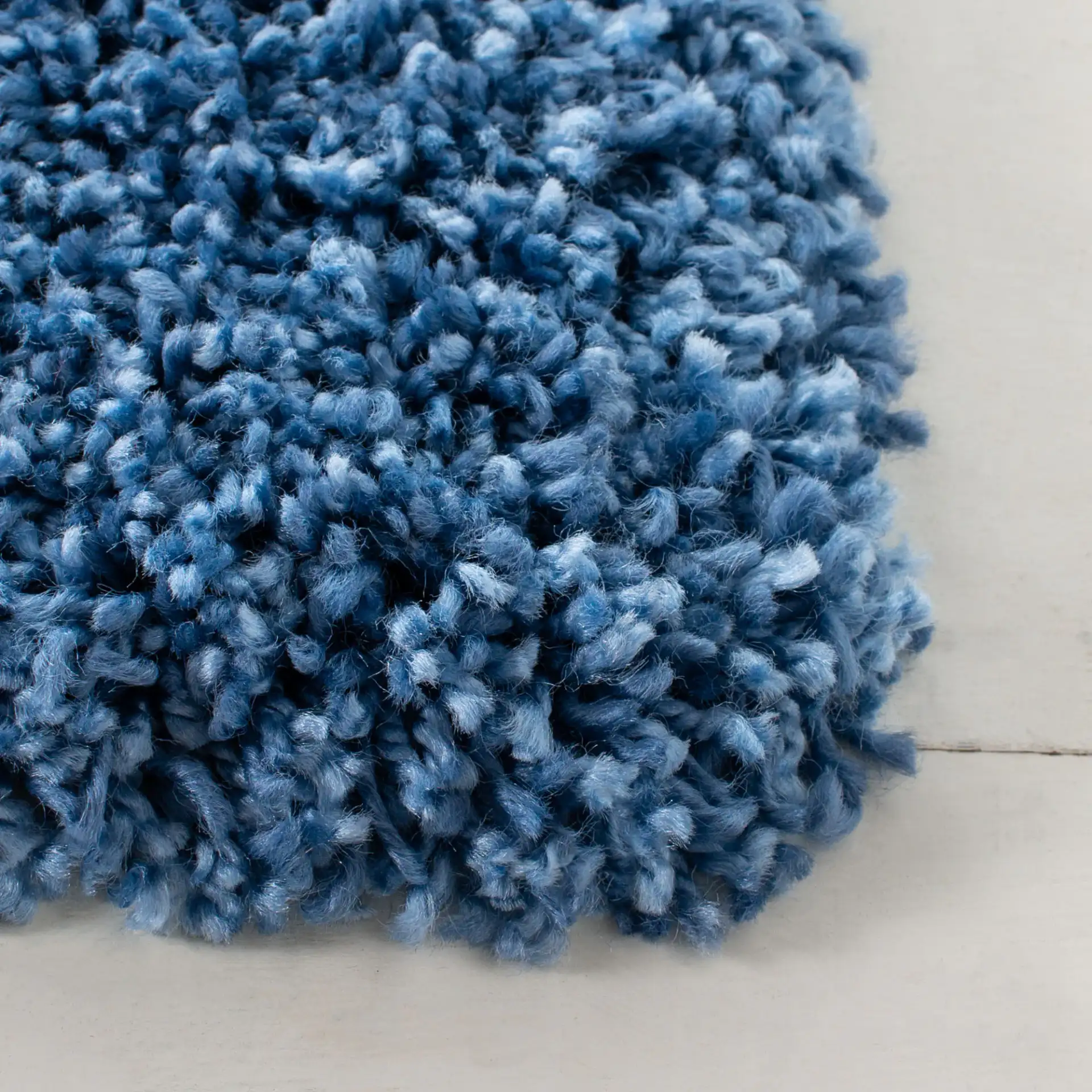 Evolution Solid Shag Rug in Blue in a styled room