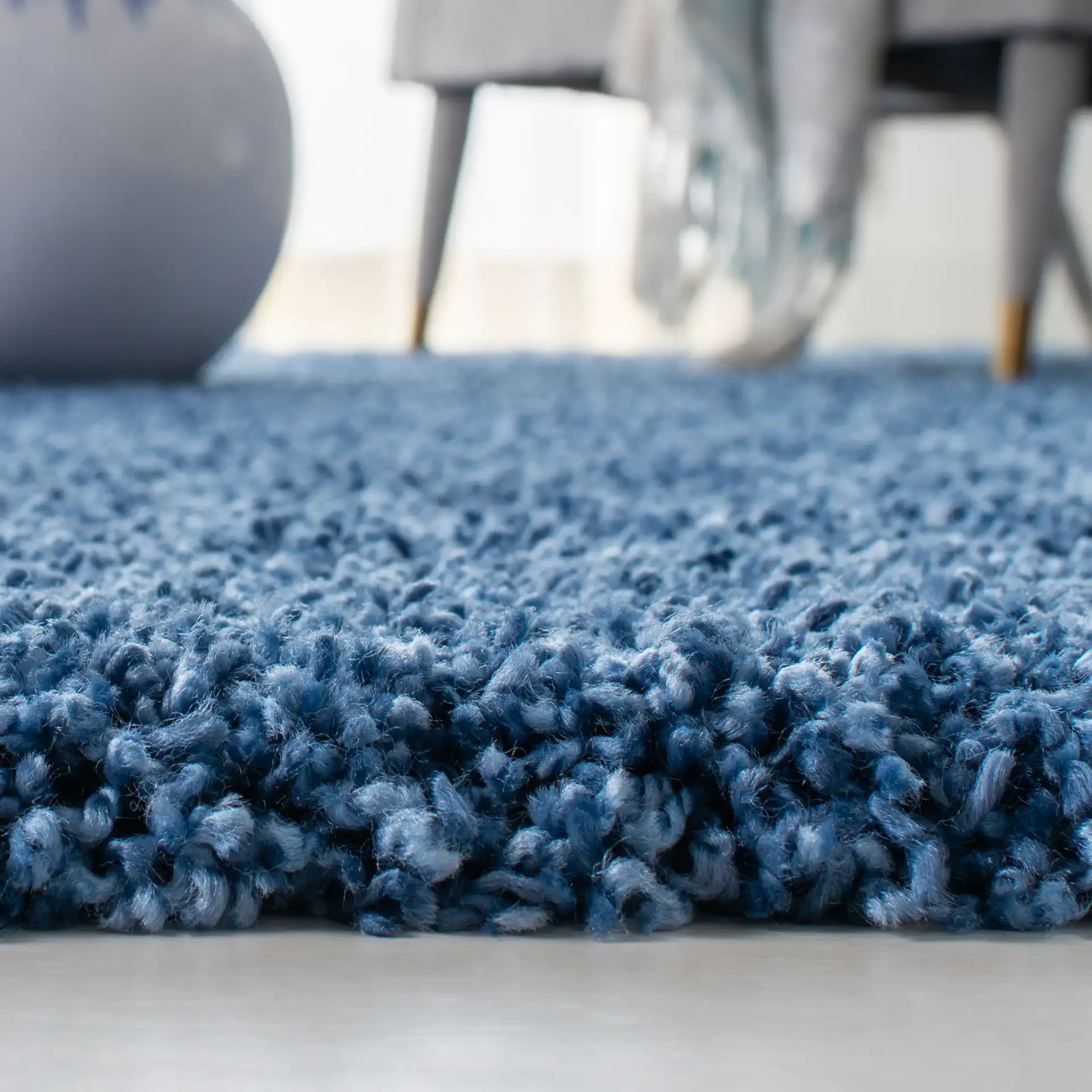 Evolution Solid Shag Rug in Blue in a styled room