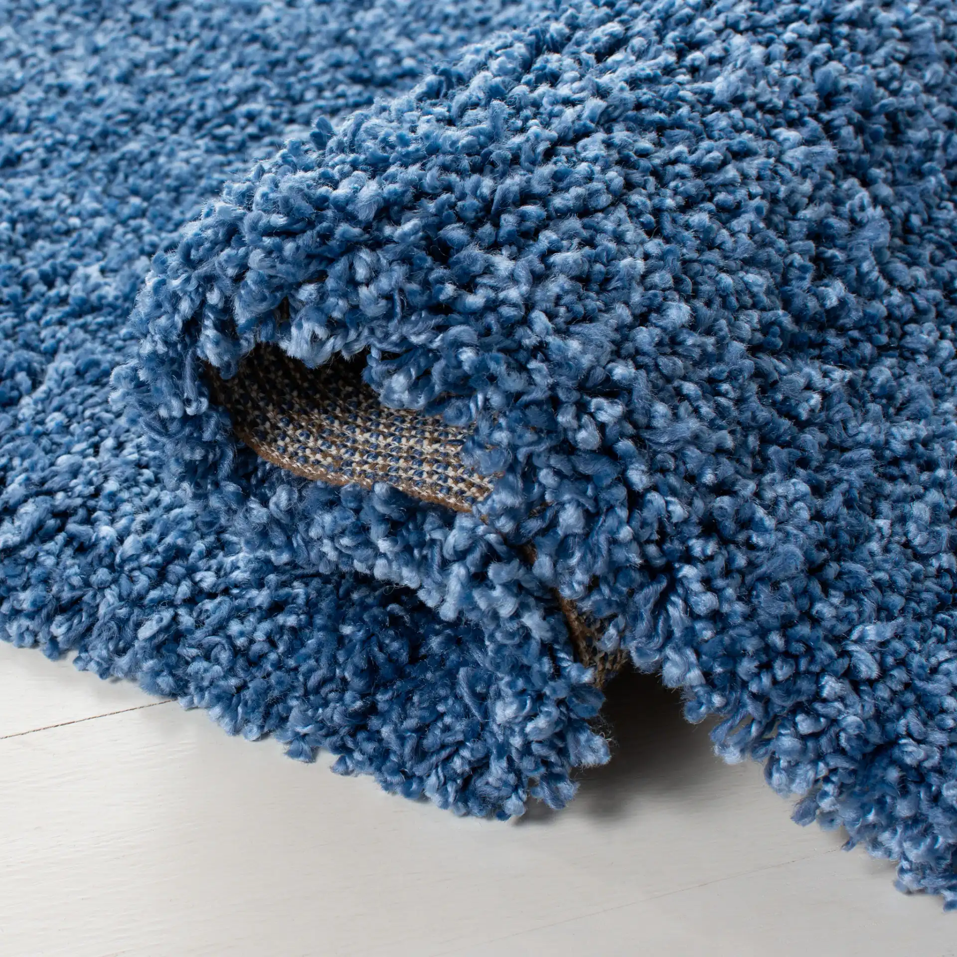 Evolution Solid Shag Rug in Blue in a styled room