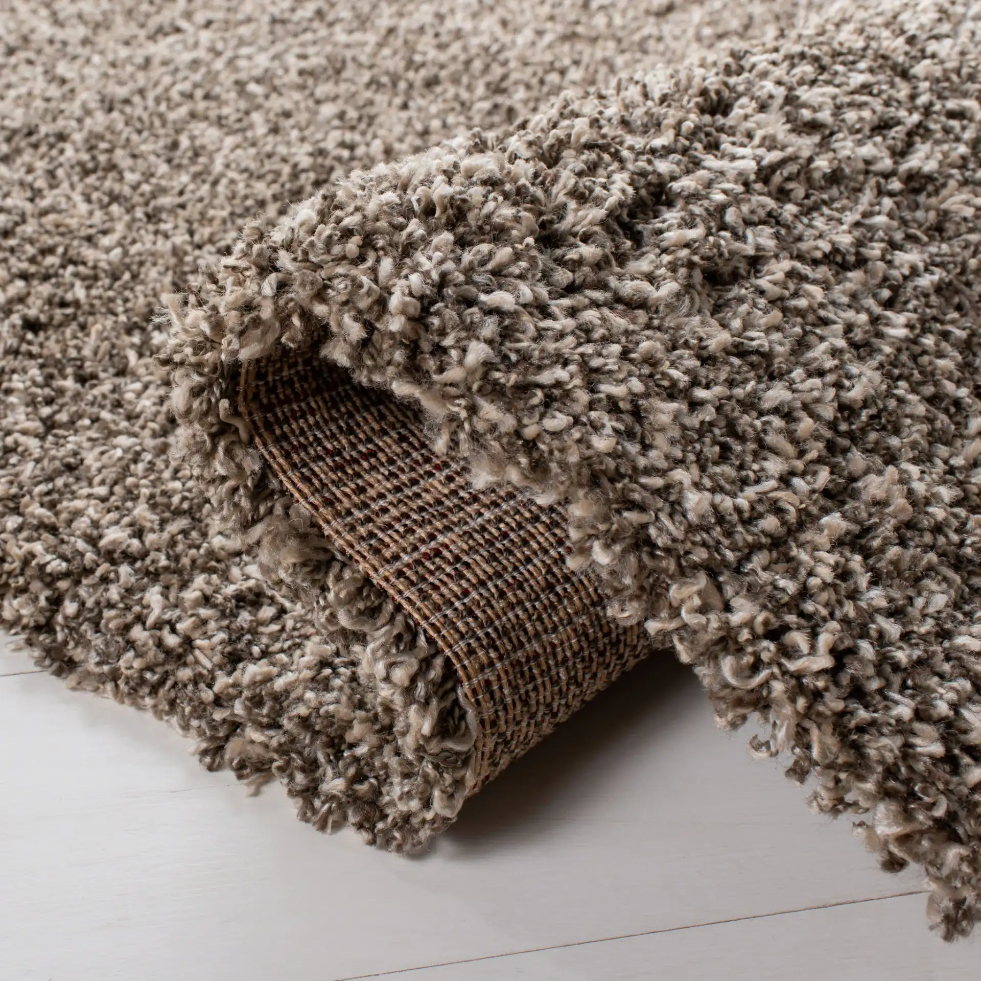Evolution Solid Shag Rug in Brown in a styled room