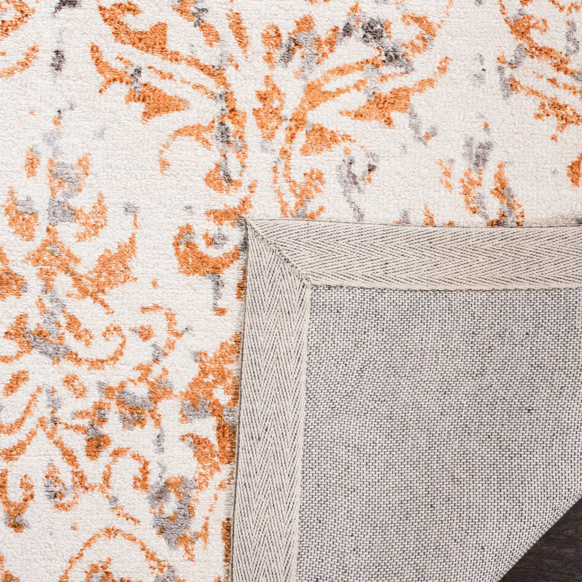 Expression Faded Damask Hand-Tufted Viscose Rug in Ivory / Rust in a styled room