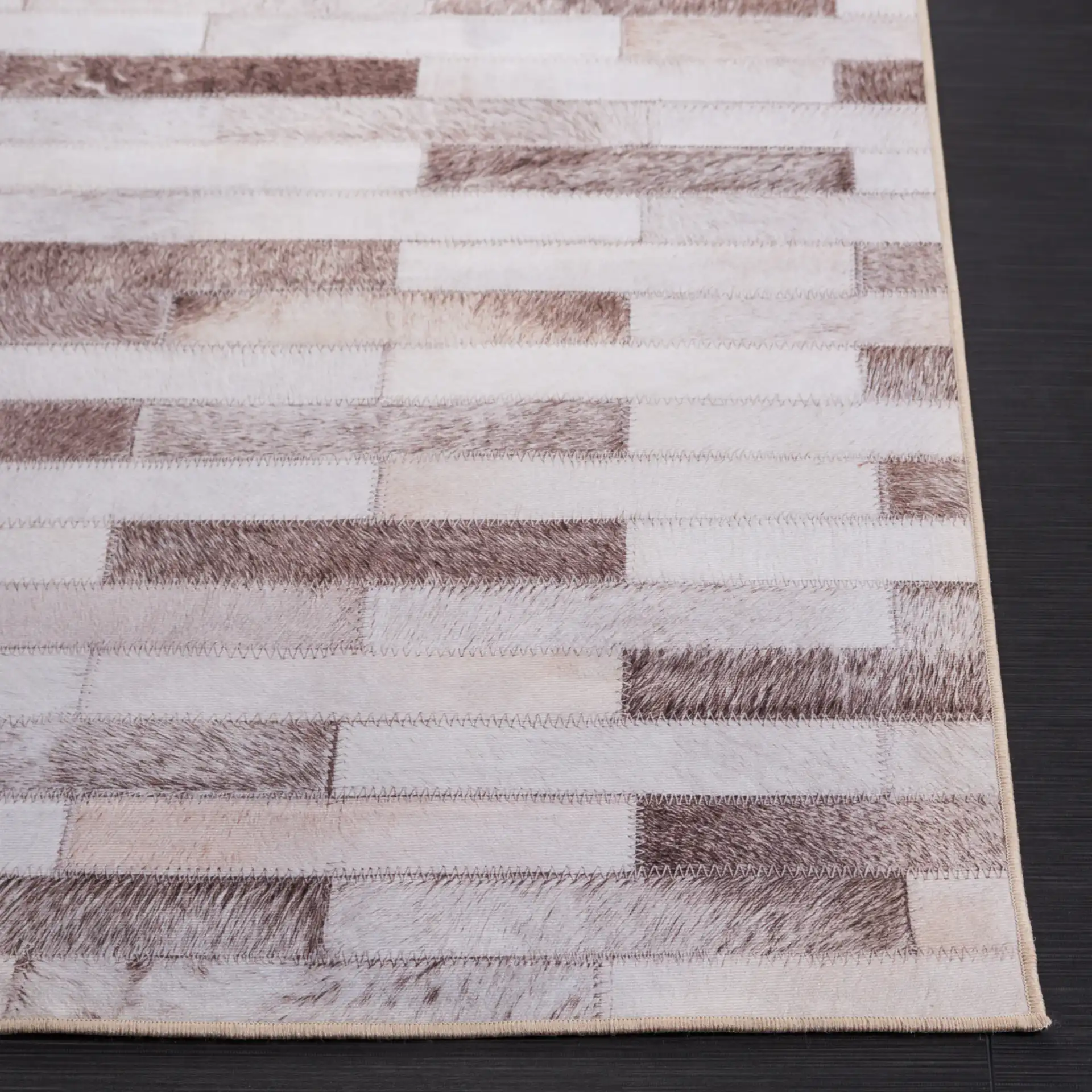 Faux Hide Brick Patchwork Washable Rug in Beige / Brown in a styled room
