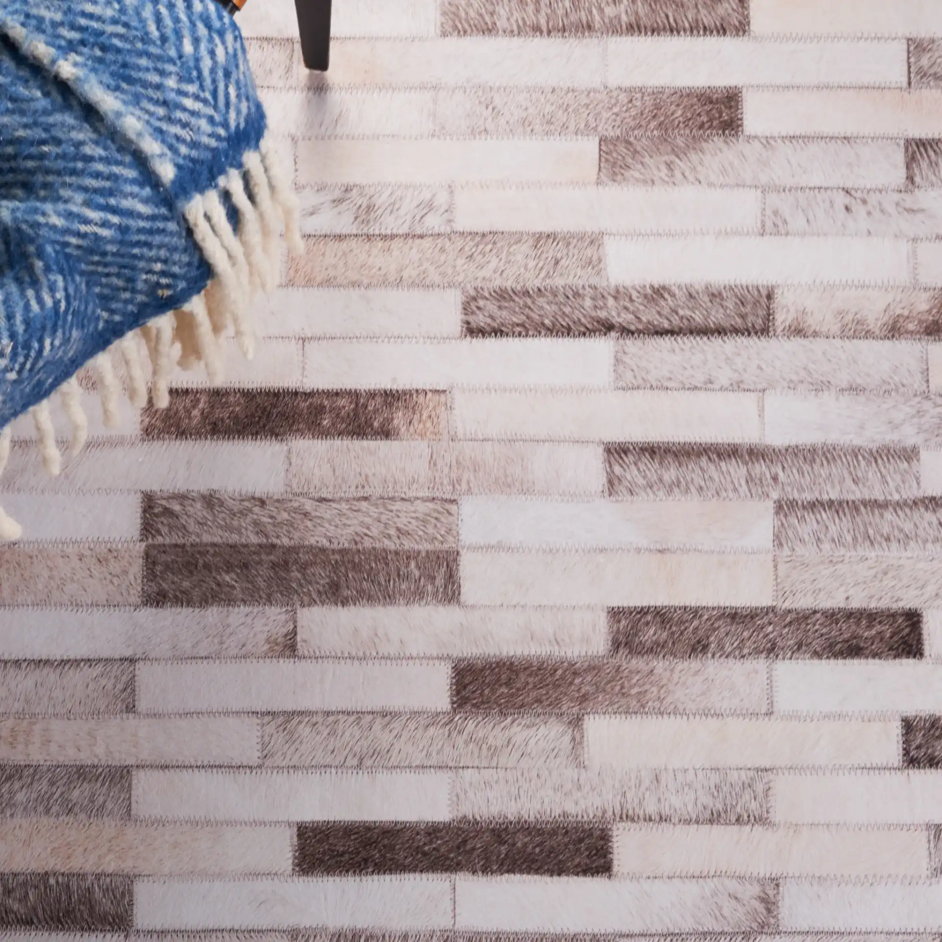 Faux Hide Brick Patchwork Washable Rug in Beige / Brown in a styled room