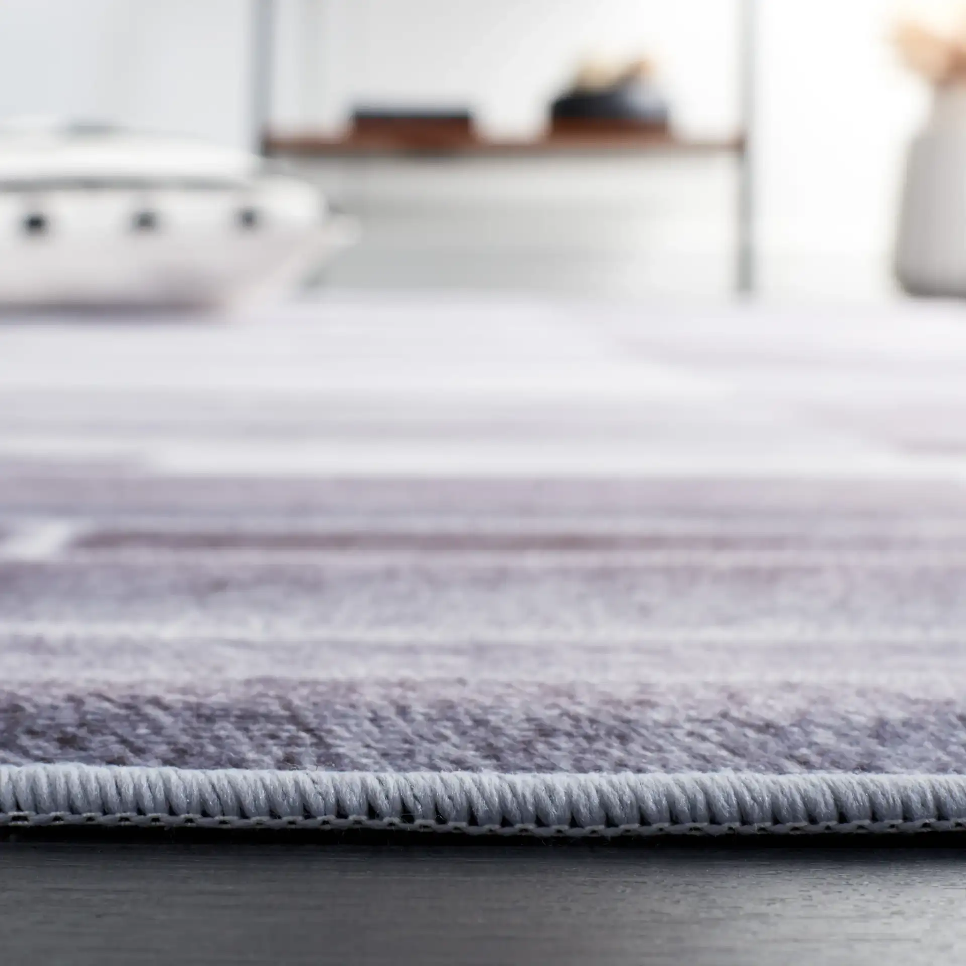 Faux Hide Linear Patchwork Washable Rug in Gray / Ivory in a styled room