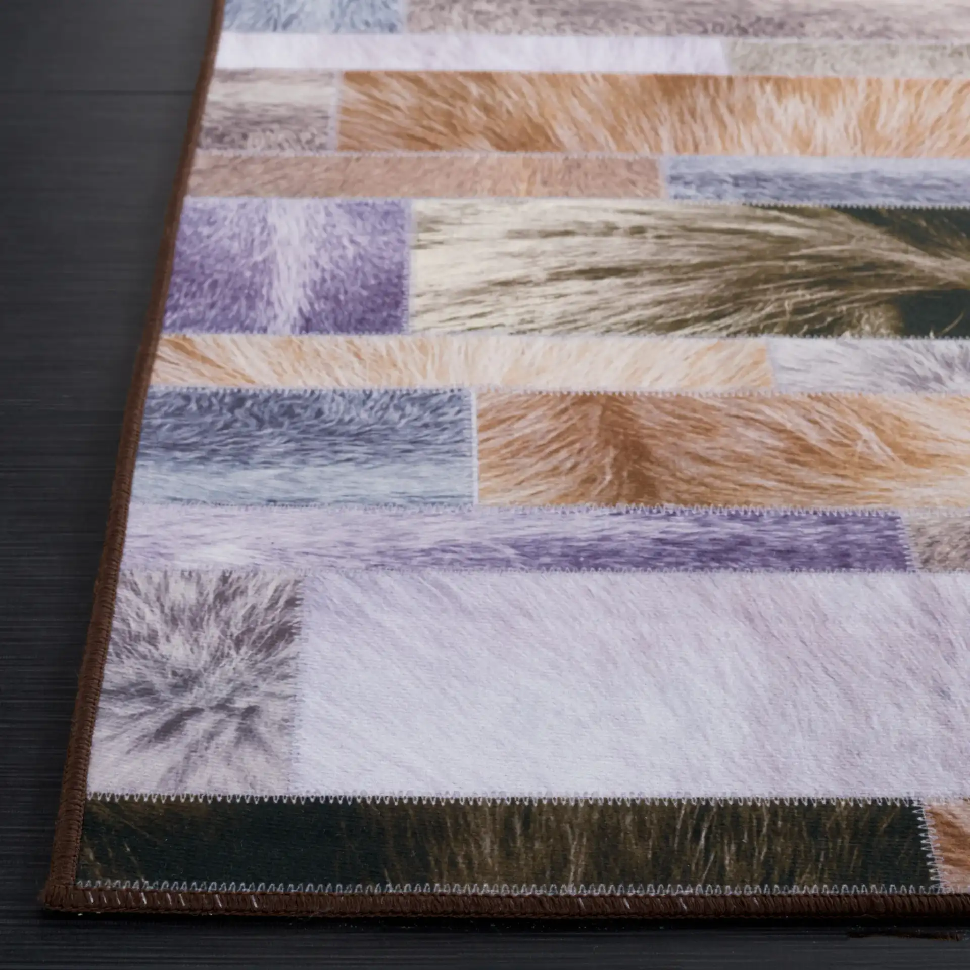 Faux Hide Linear Patchwork Washable Rug in Beige / Purple in a styled room