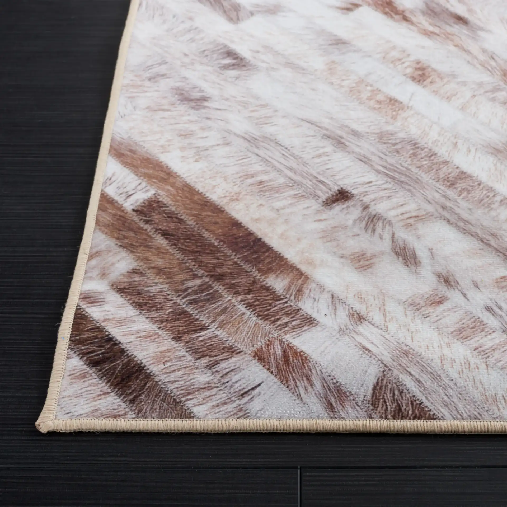 Faux Hide Patchwork Diamond Washable Rug in Beige / Brown in a styled room