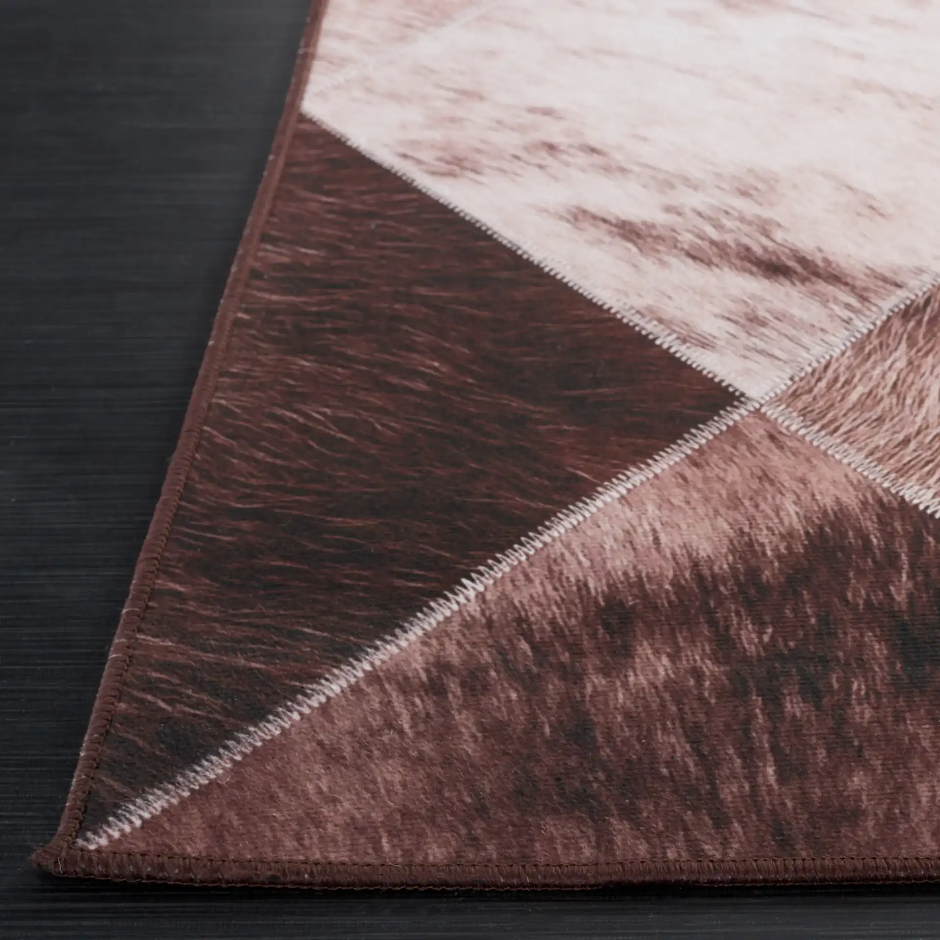 Faux Hide Diamond Patchwork Washable Rug in Light Brown / Brown in a styled room