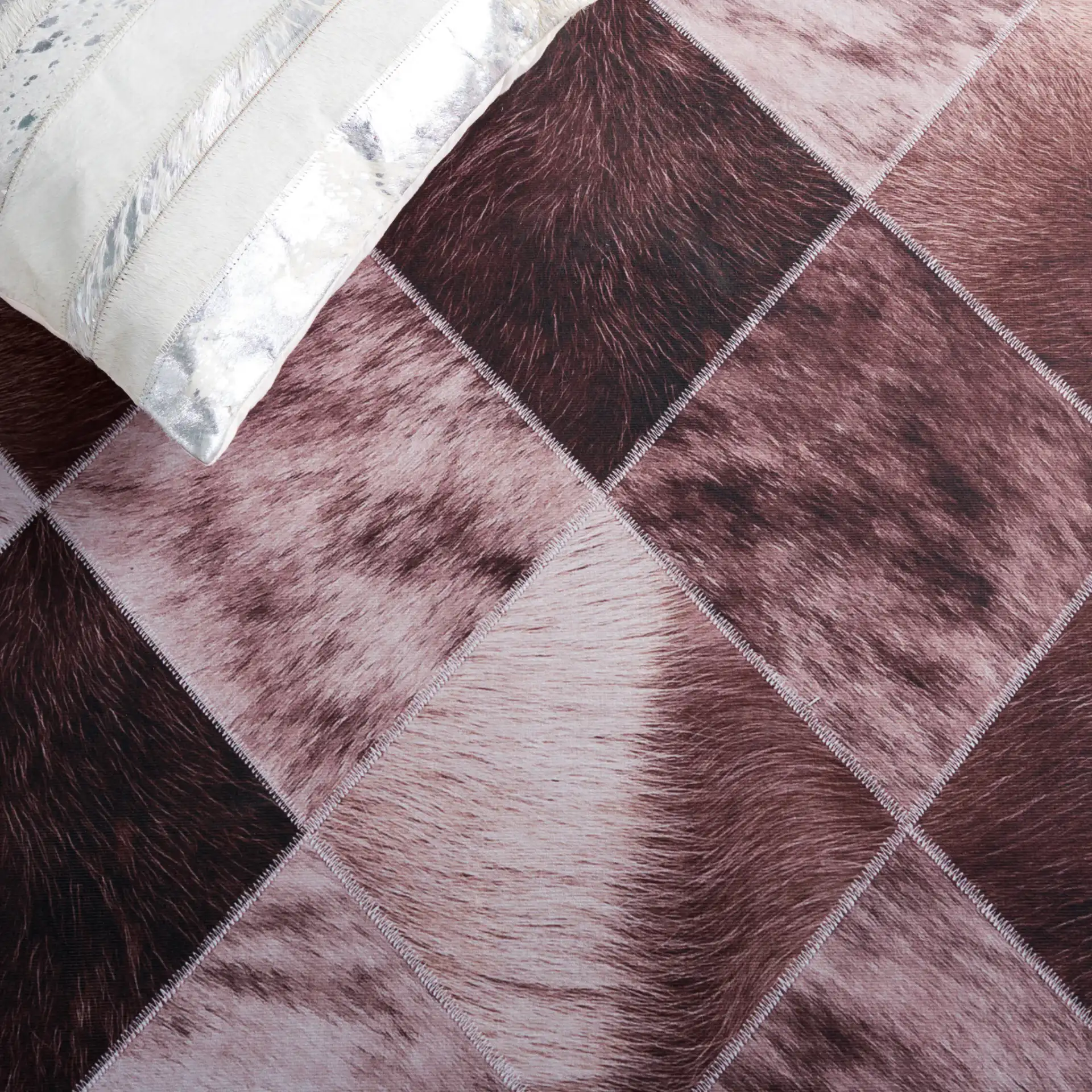 Faux Hide Diamond Patchwork Washable Rug in Light Brown / Brown in a styled room