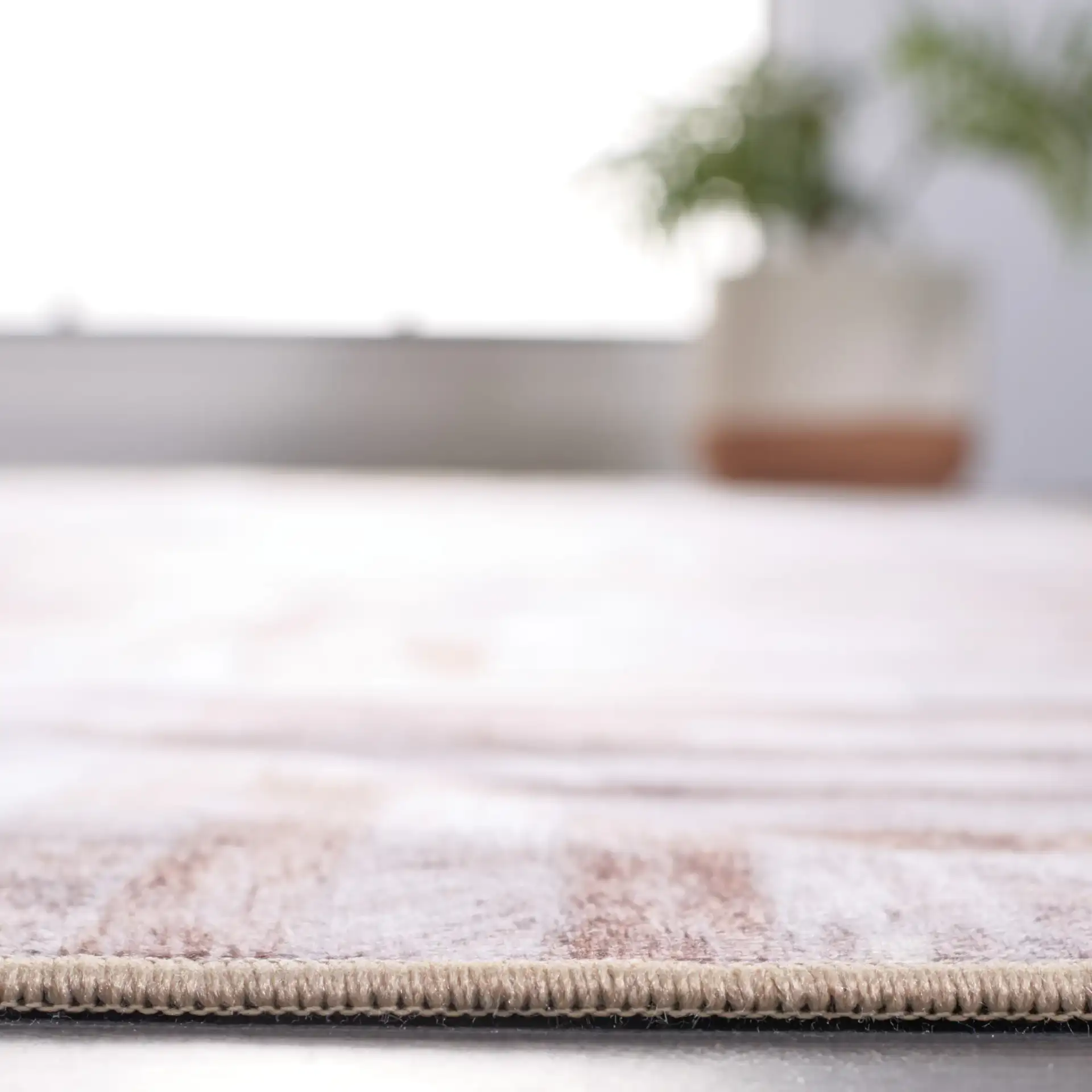 Faux Hide Concentric Square Patchwork Washable Rug in Beige / Brown in a styled room