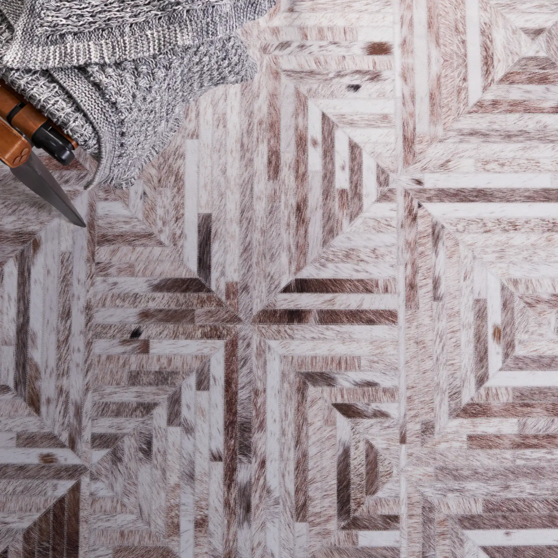 Faux Hide Concentric Square Patchwork Washable Rug in Beige / Brown in a styled room