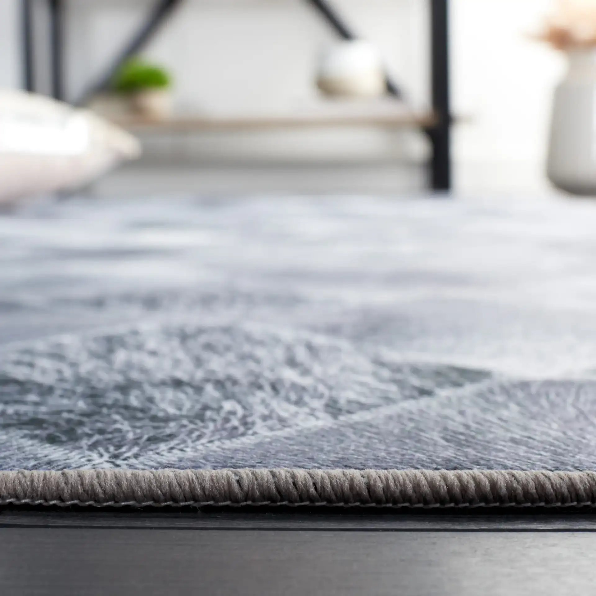 Faux Hide Harlequin Patchwork Washable Rug in Gray / Dark Gray in a styled room