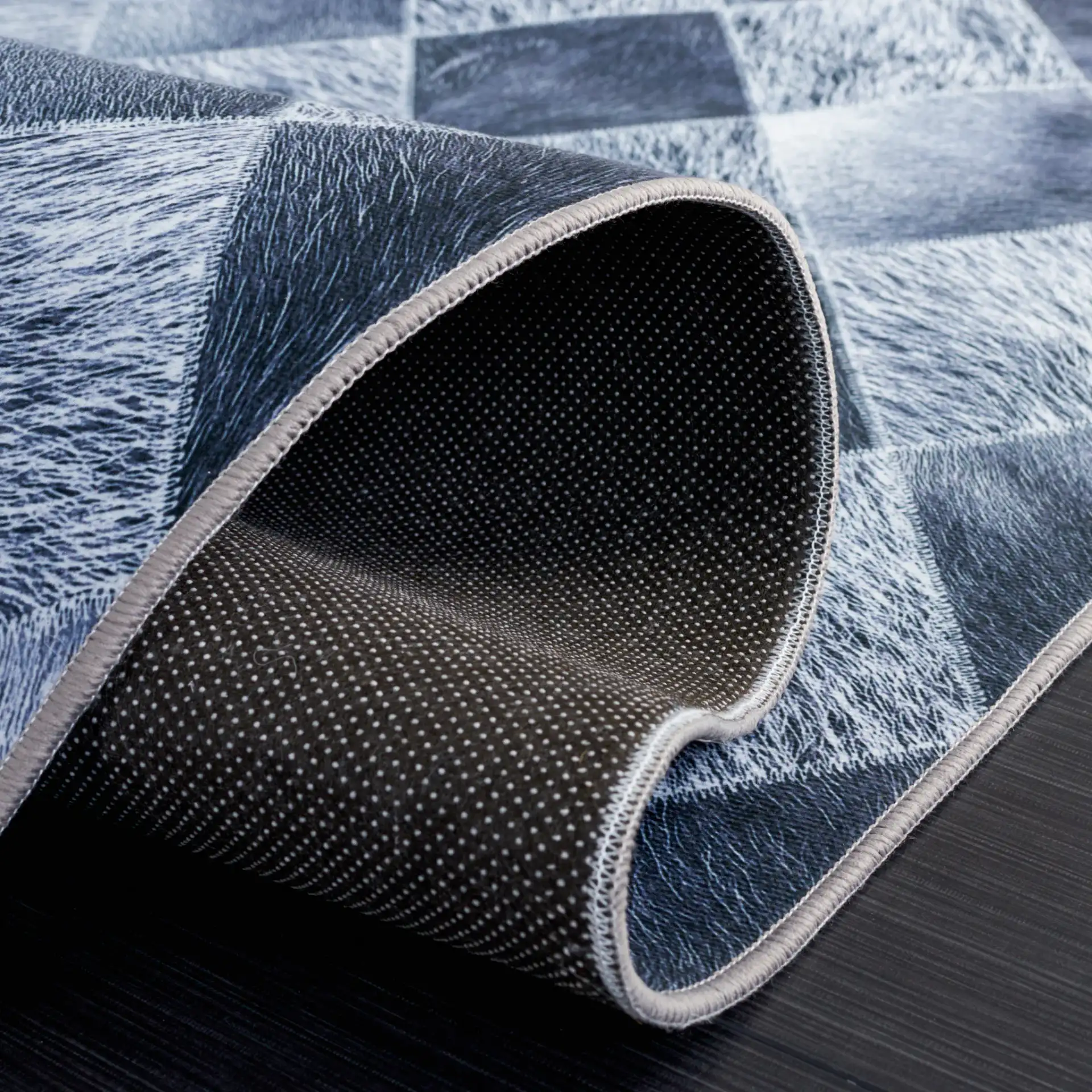 Faux Hide Harlequin Patchwork Washable Rug in Gray / Dark Gray in a styled room