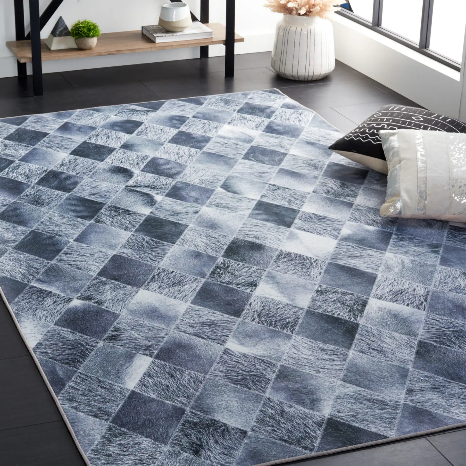 Faux Hide Harlequin Patchwork Washable Rug in Gray / Dark Gray in a styled room
