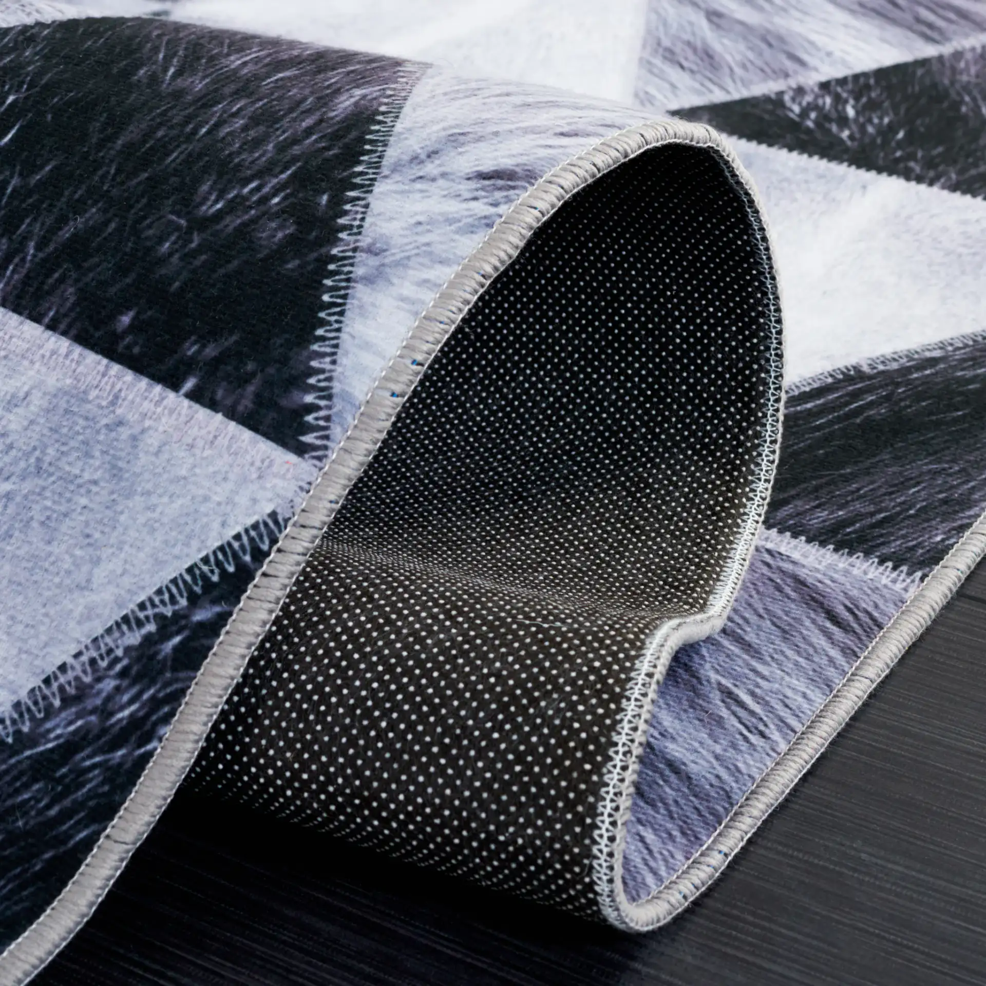 Faux Hide Triangle Patchwork Washable Rug in Light Gray / Dark Gray in a styled room