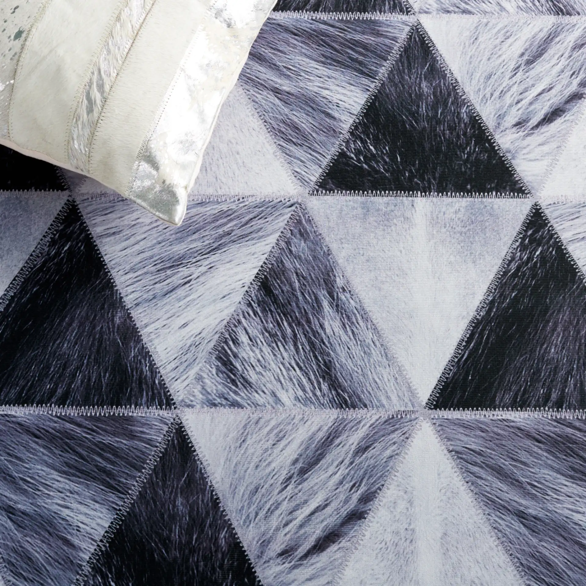 Faux Hide Triangle Patchwork Washable Rug in Light Gray / Dark Gray in a styled room