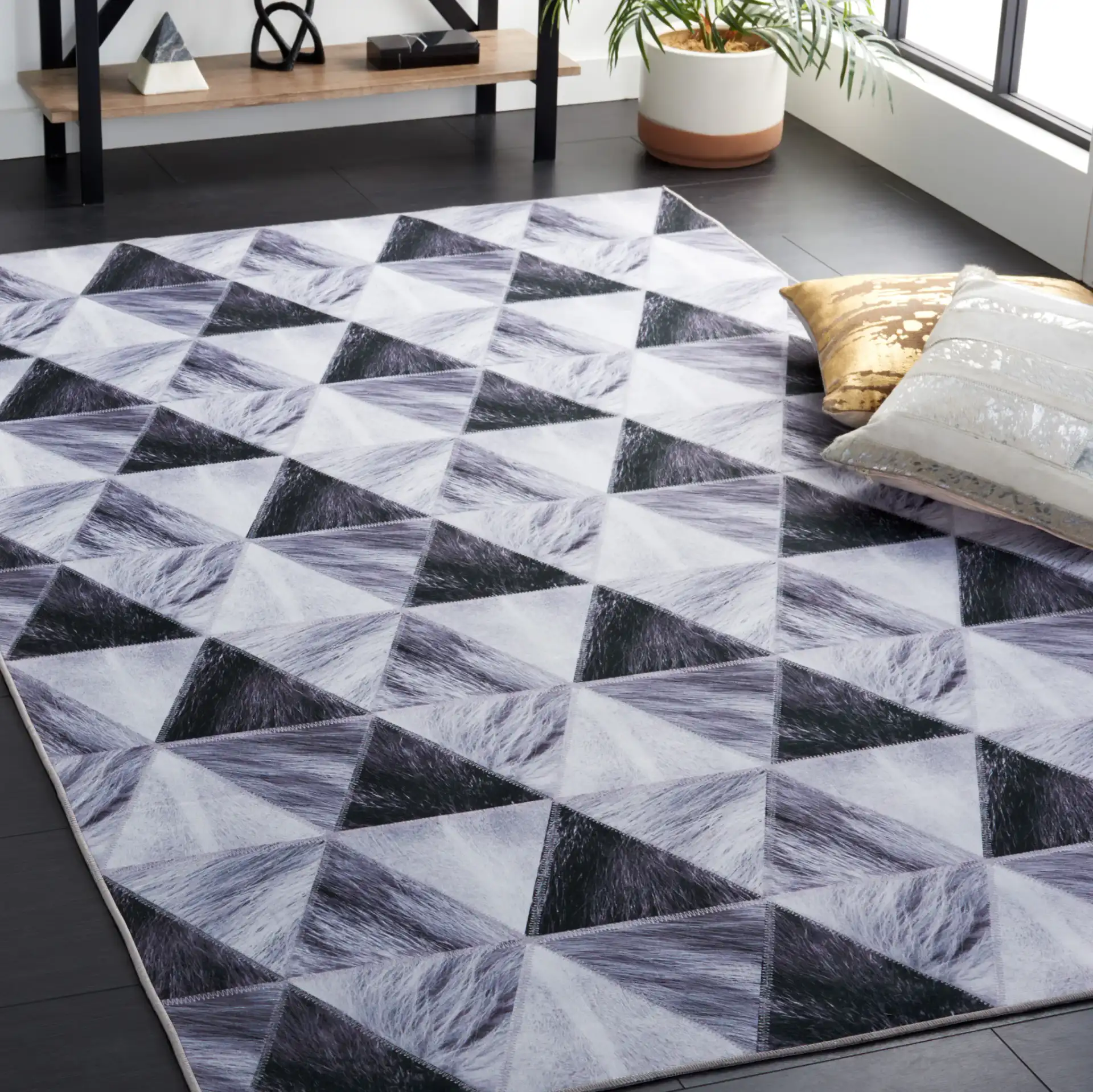 Faux Hide Triangle Patchwork Washable Rug in Light Gray / Dark Gray in a styled room