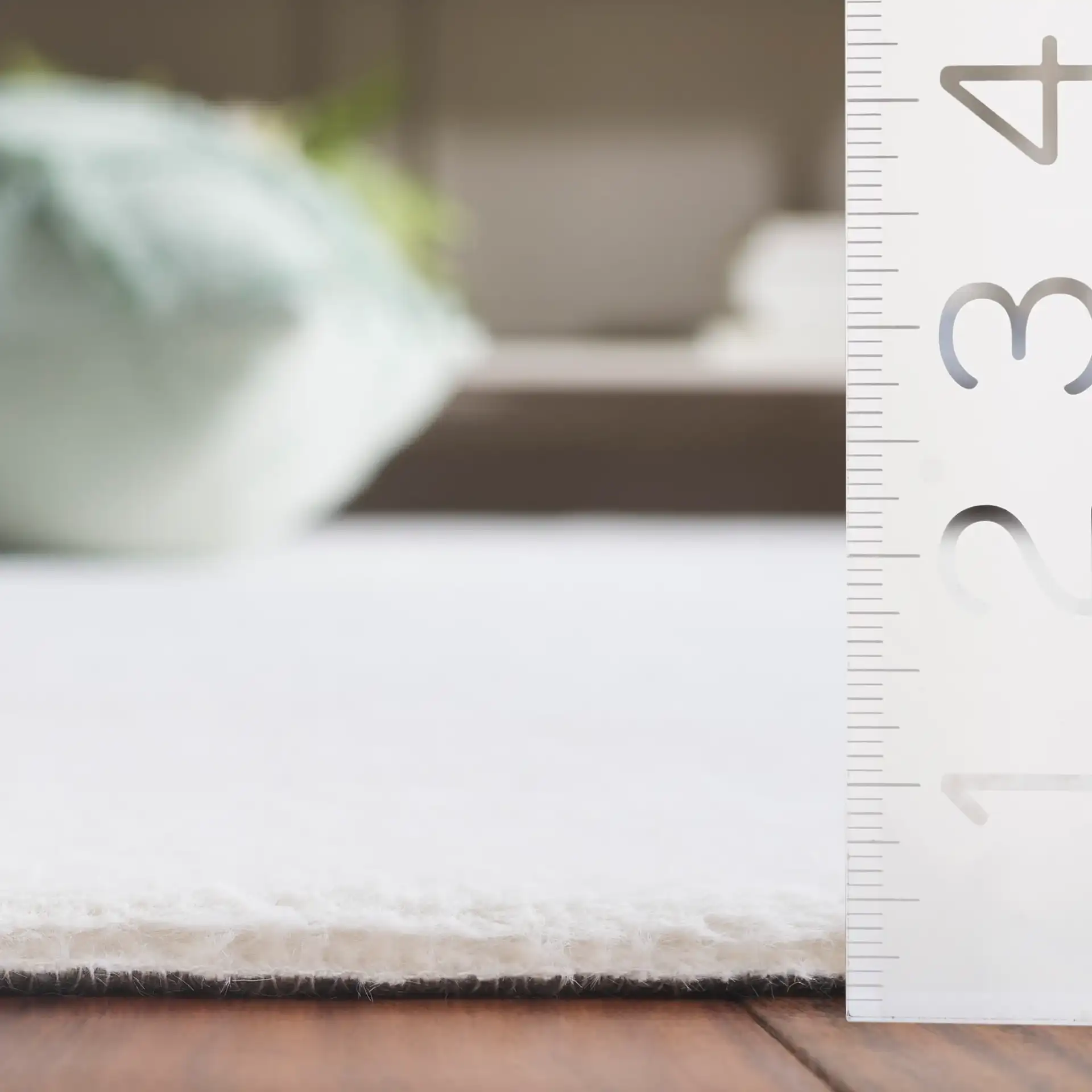 Faux Fur Solid Washable Rug in Ivory in a styled room