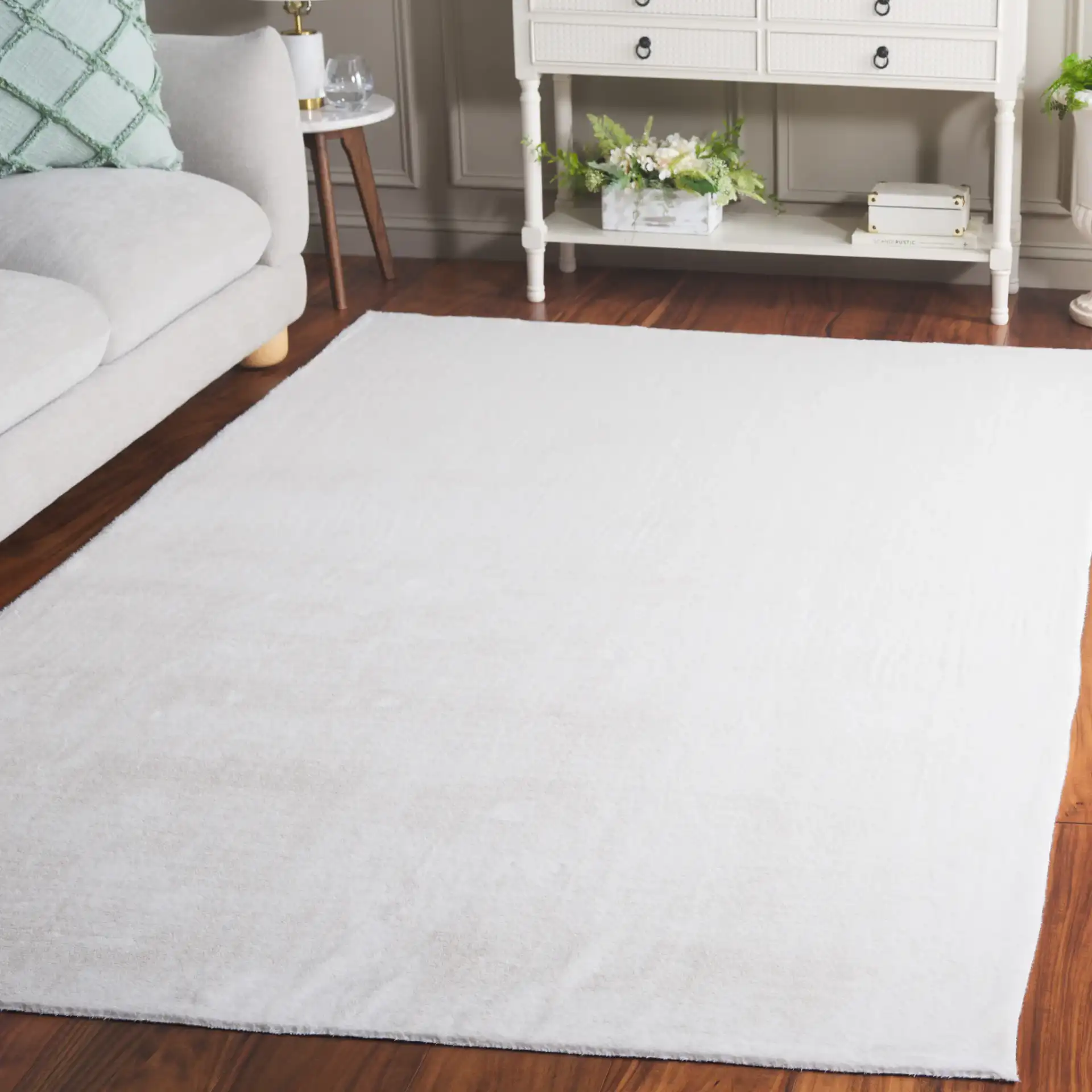 Faux Fur Solid Washable Rug in Ivory in a styled room