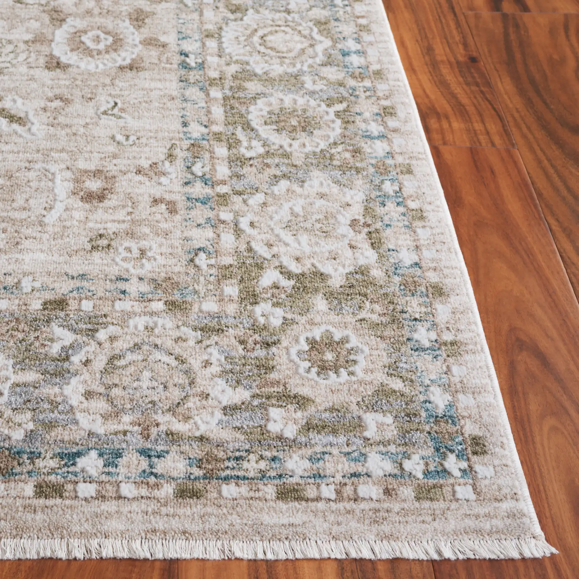 Finley Floral Bordered Rug in Green / Beige in a styled room