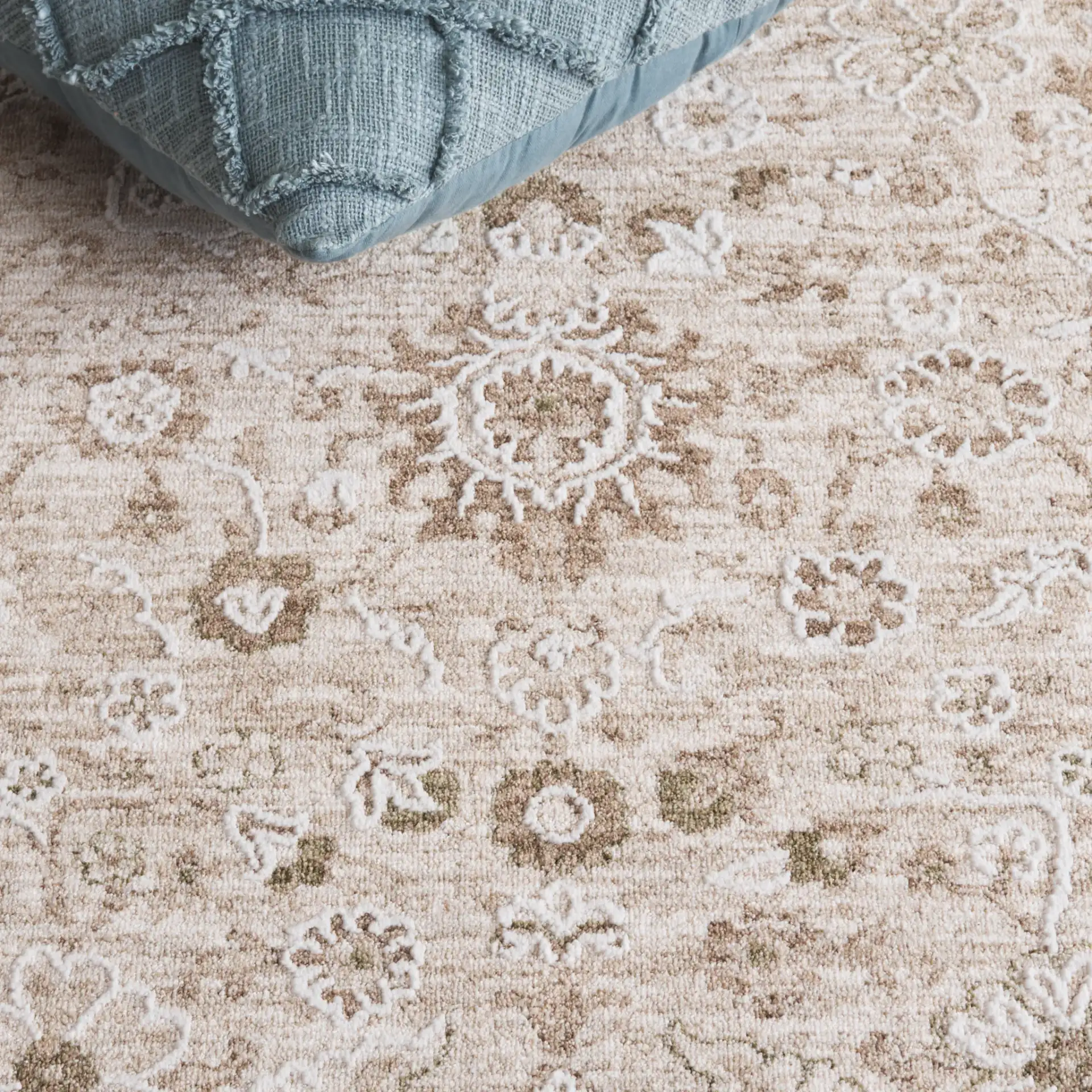 Finley Floral Bordered Rug in Green / Beige in a styled room