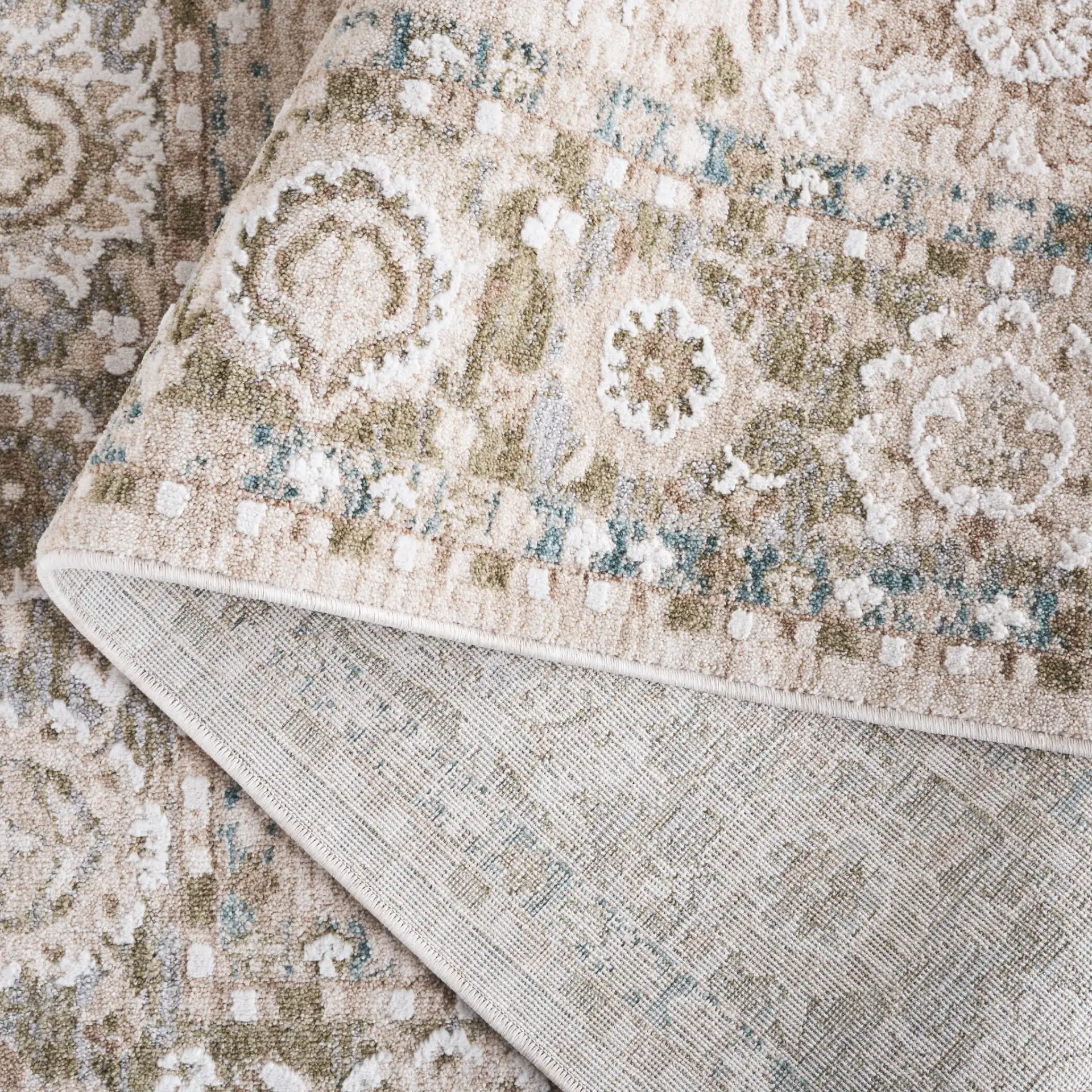 Finley Floral Bordered Rug in Green / Beige in a styled room