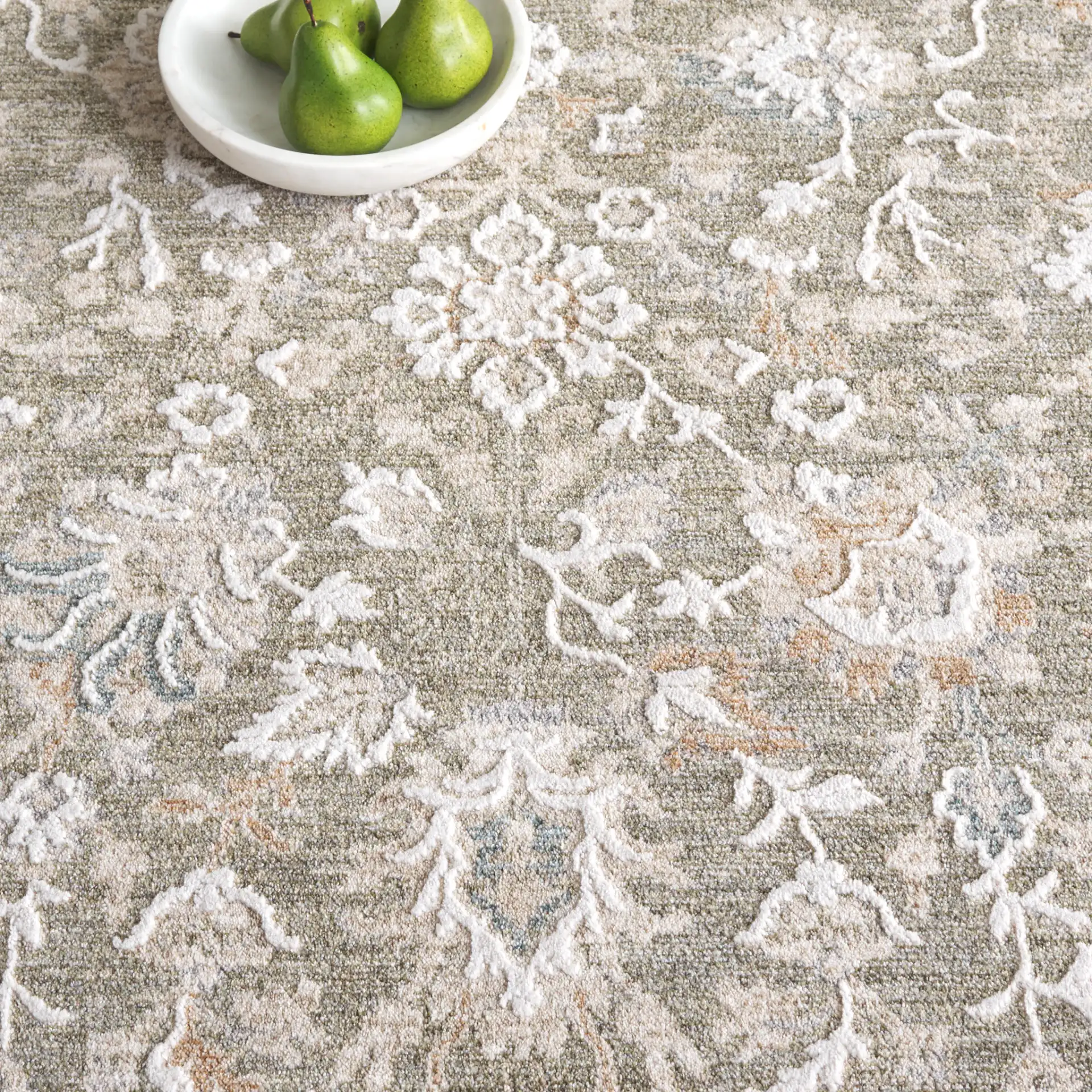 Finley Botanical Border Rug in Green / Beige in a styled room