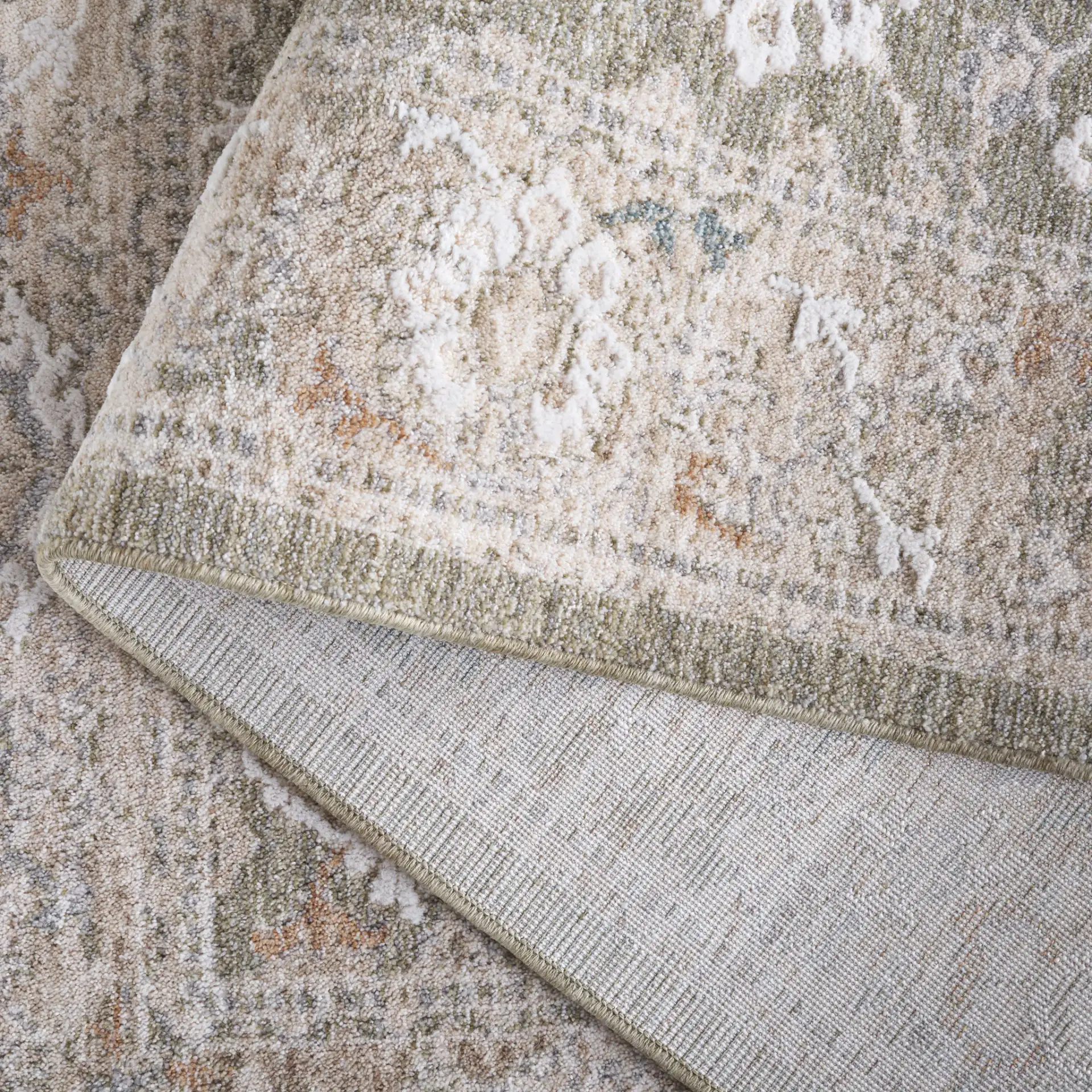 Finley Botanical Border Rug in Green / Beige in a styled room