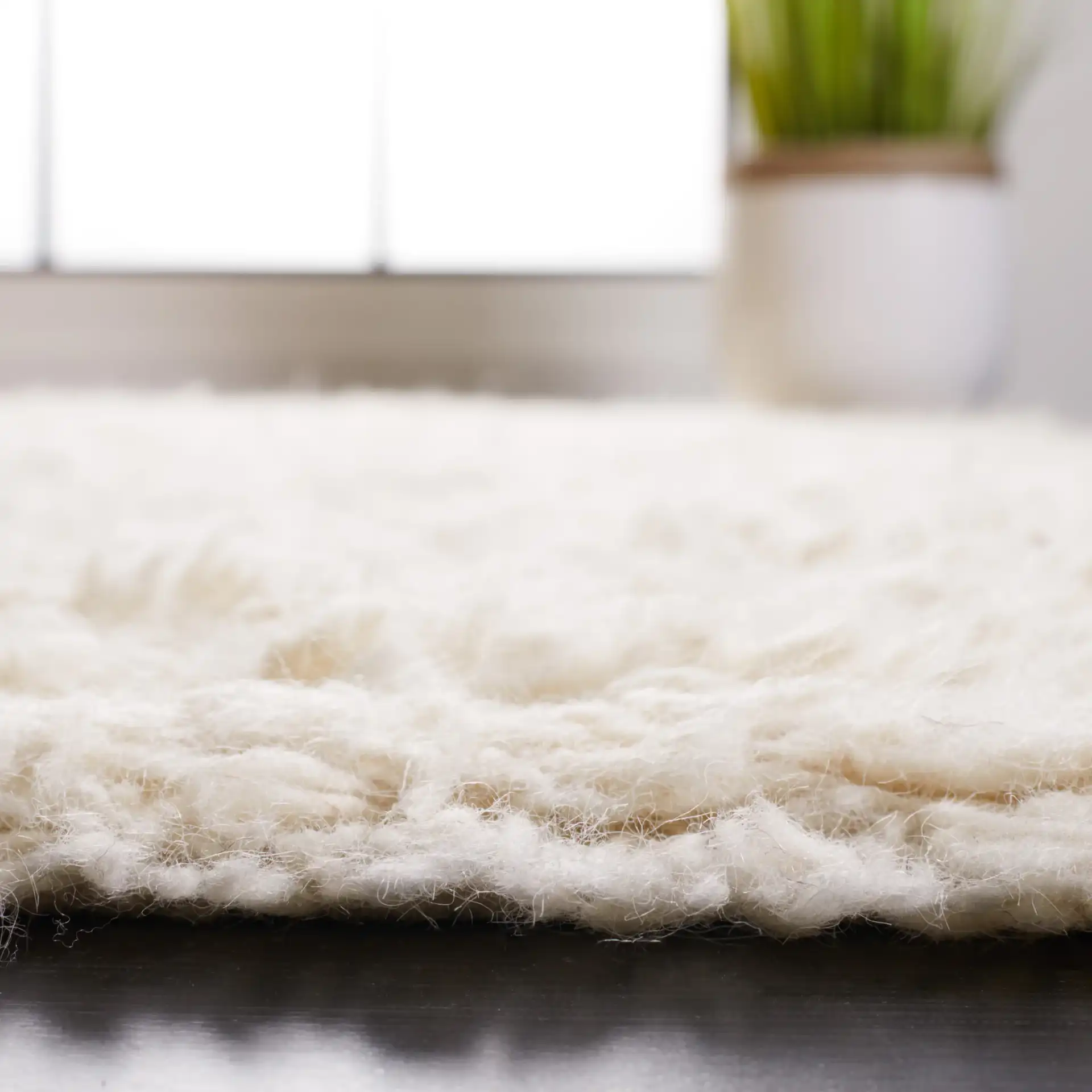 Flokati Solid Hand-Tufted Wool Shag Rug in Ivory in a styled room