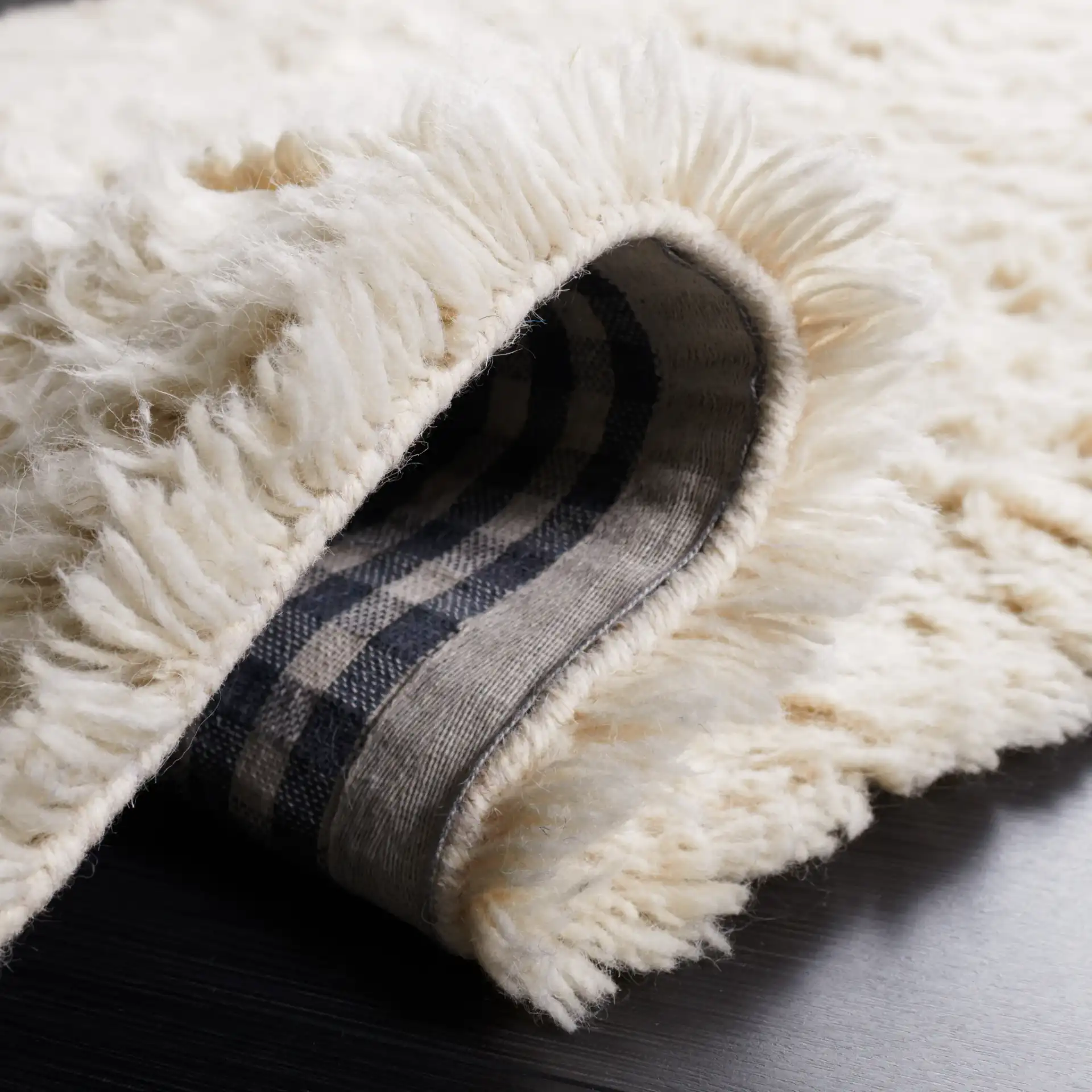 Flokati Solid Hand-Tufted Wool Shag Rug in Ivory in a styled room