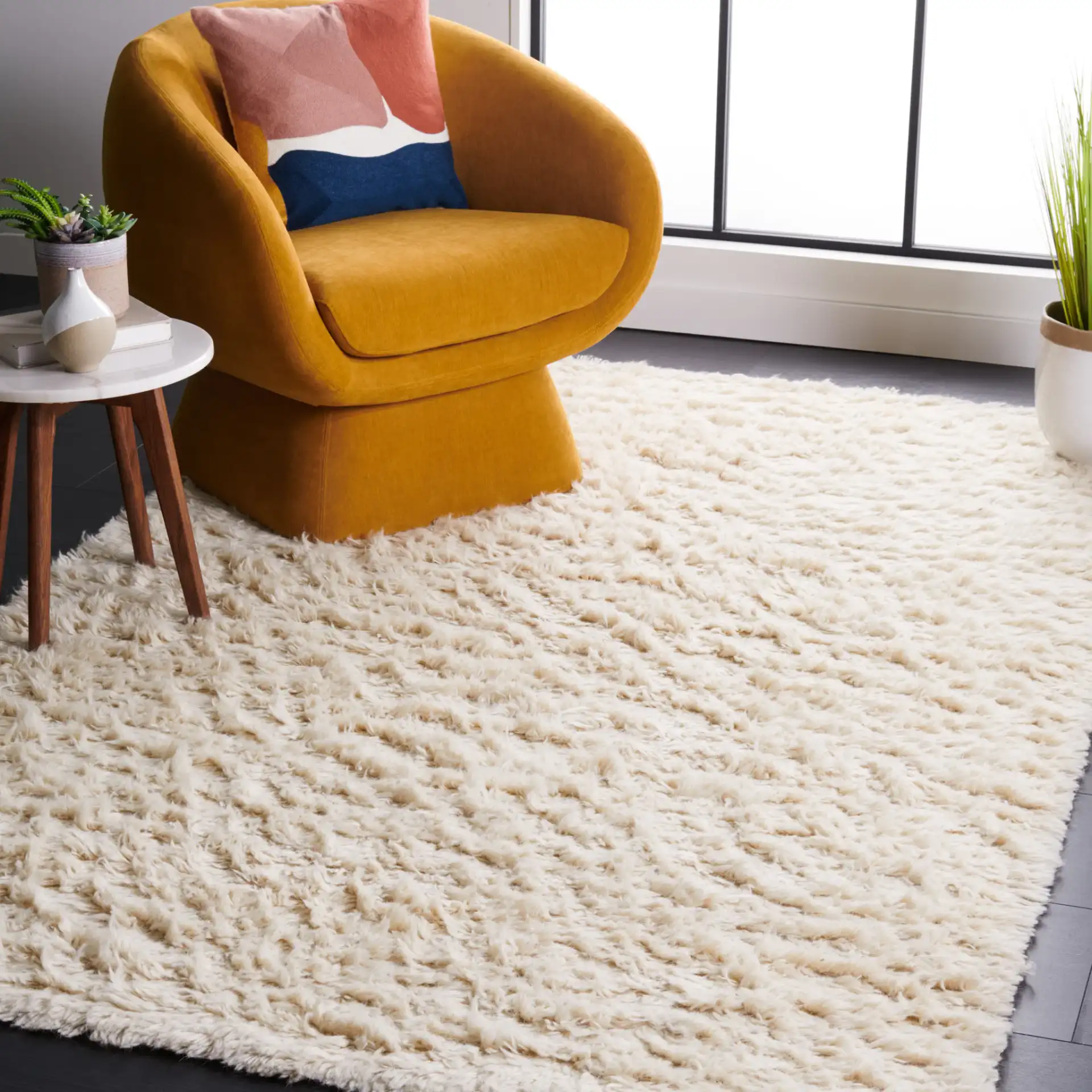 Flokati Solid Hand-Tufted Wool Shag Rug in Ivory in a styled room