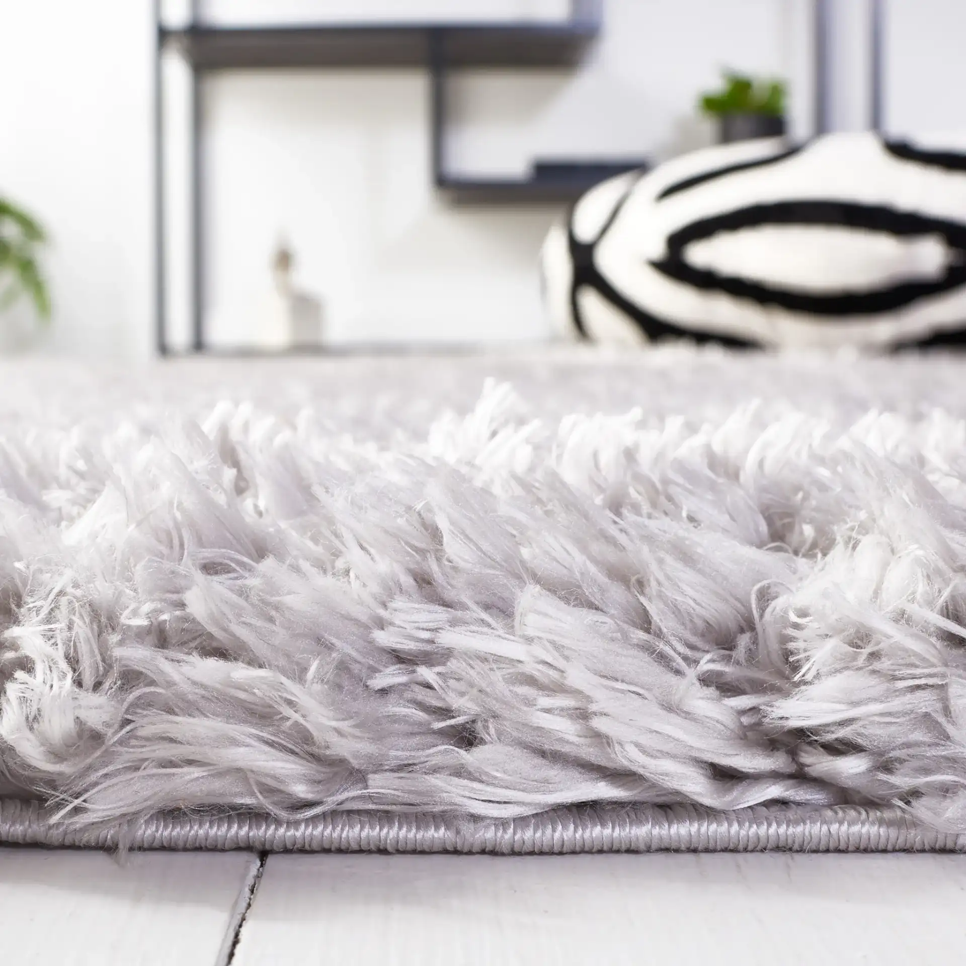 Flokati Solid Shag Rug in Silver in a styled room