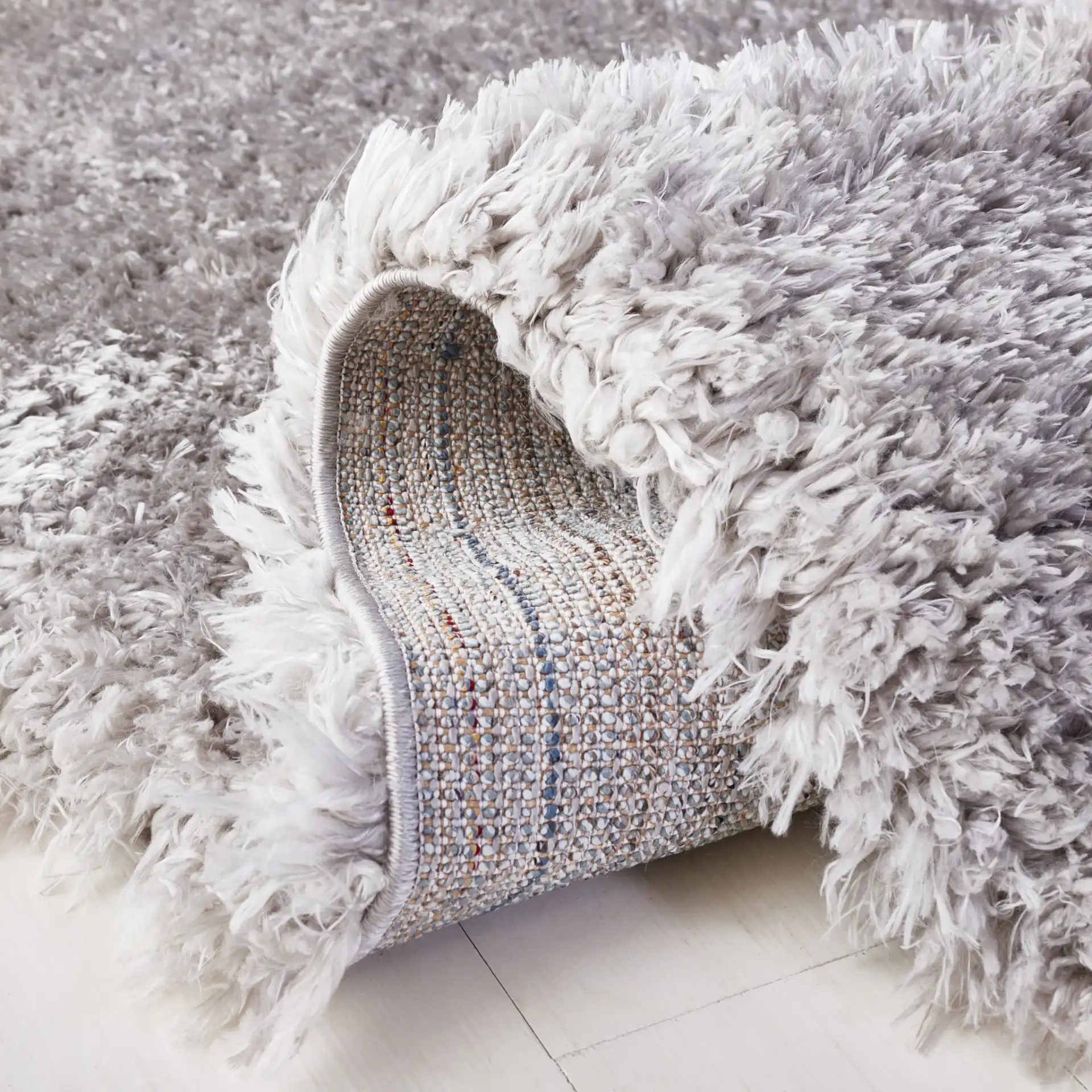 Flokati Solid Shag Rug in Silver in a styled room