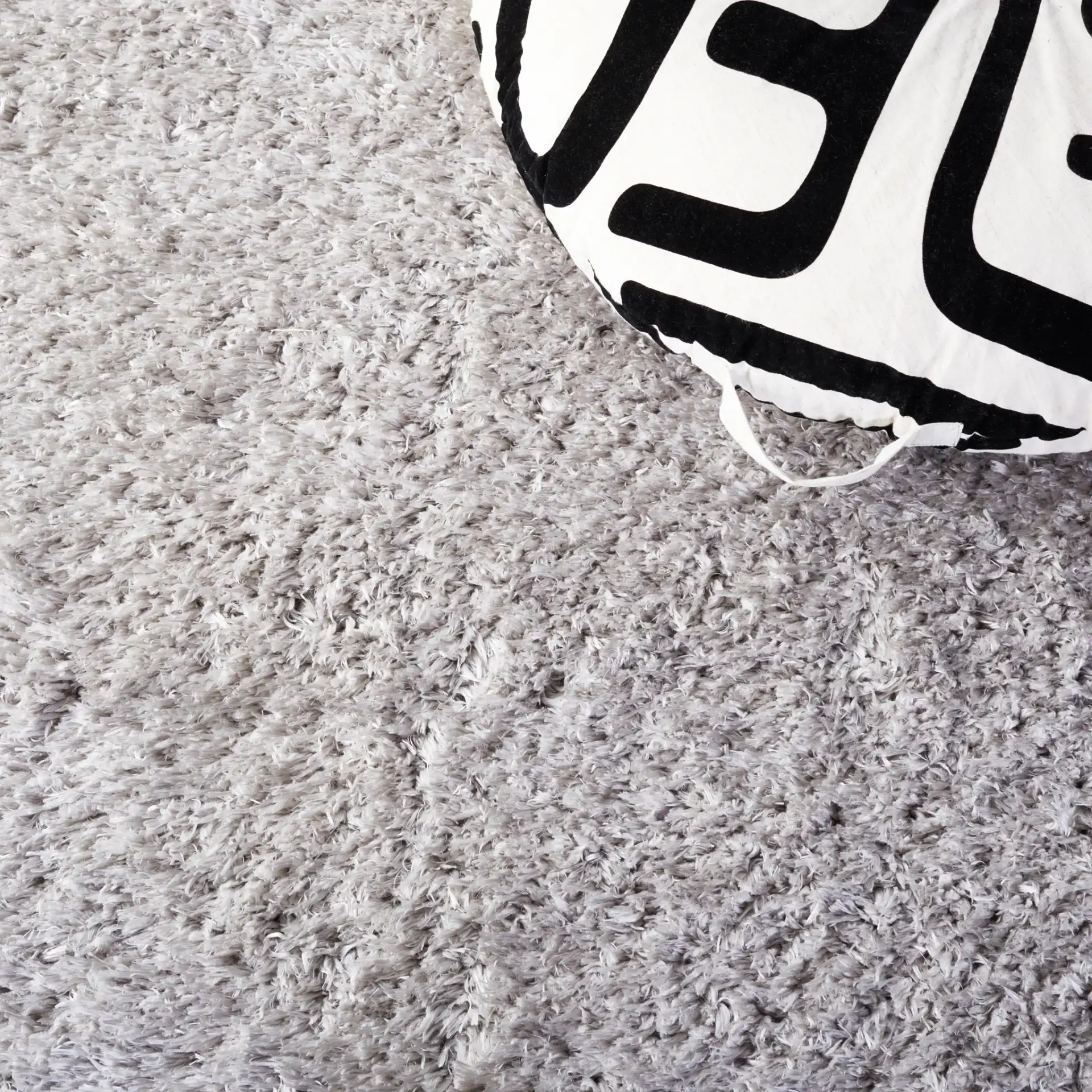 Flokati Solid Shag Rug in Silver in a styled room
